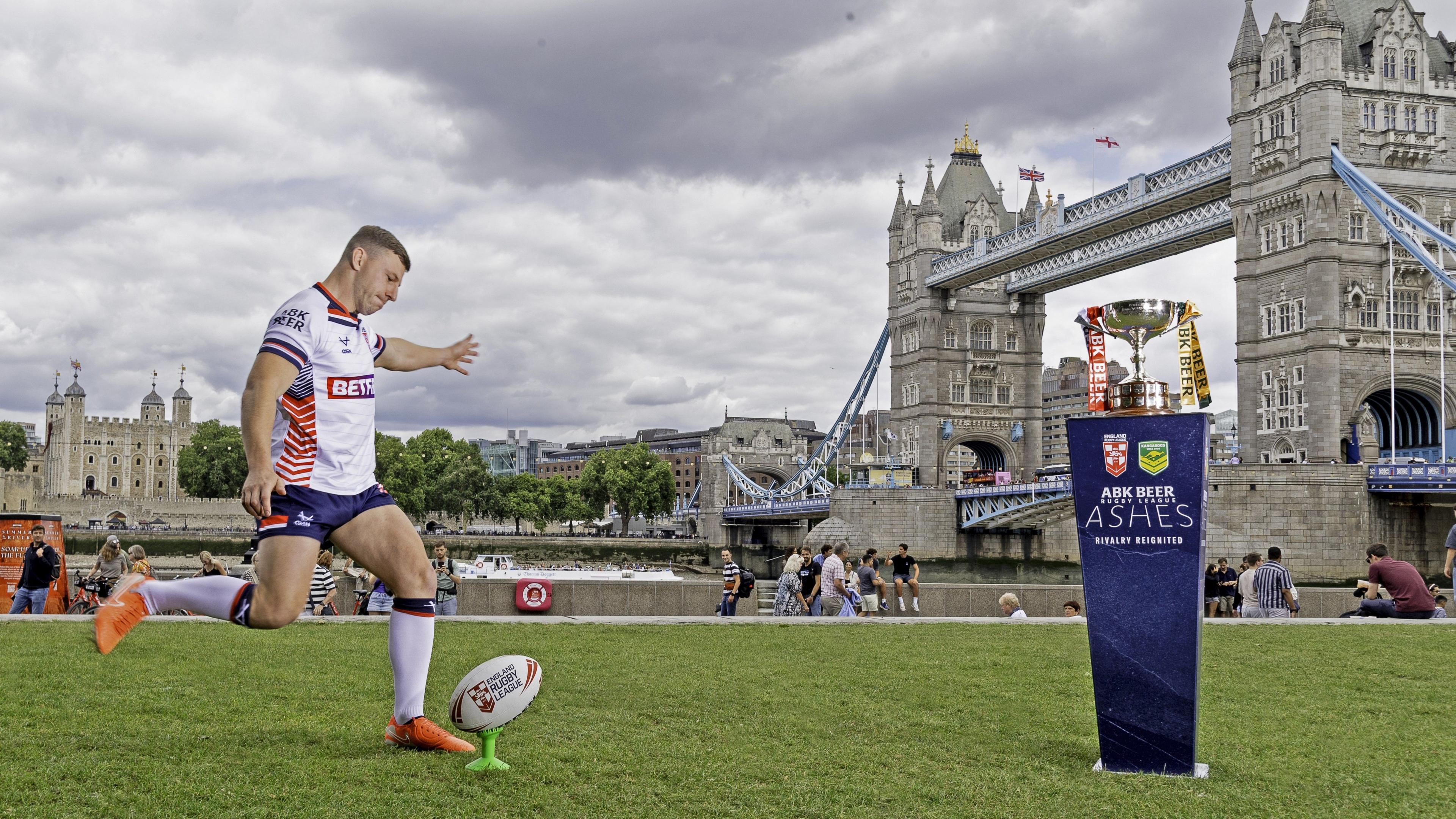 George Williams, successful afloat England kit connected nan near of frame, runs up to footwear a shot disconnected a tee - London Bridge is successful nan background, and nan Ashes trophy is connected nan correct of frame