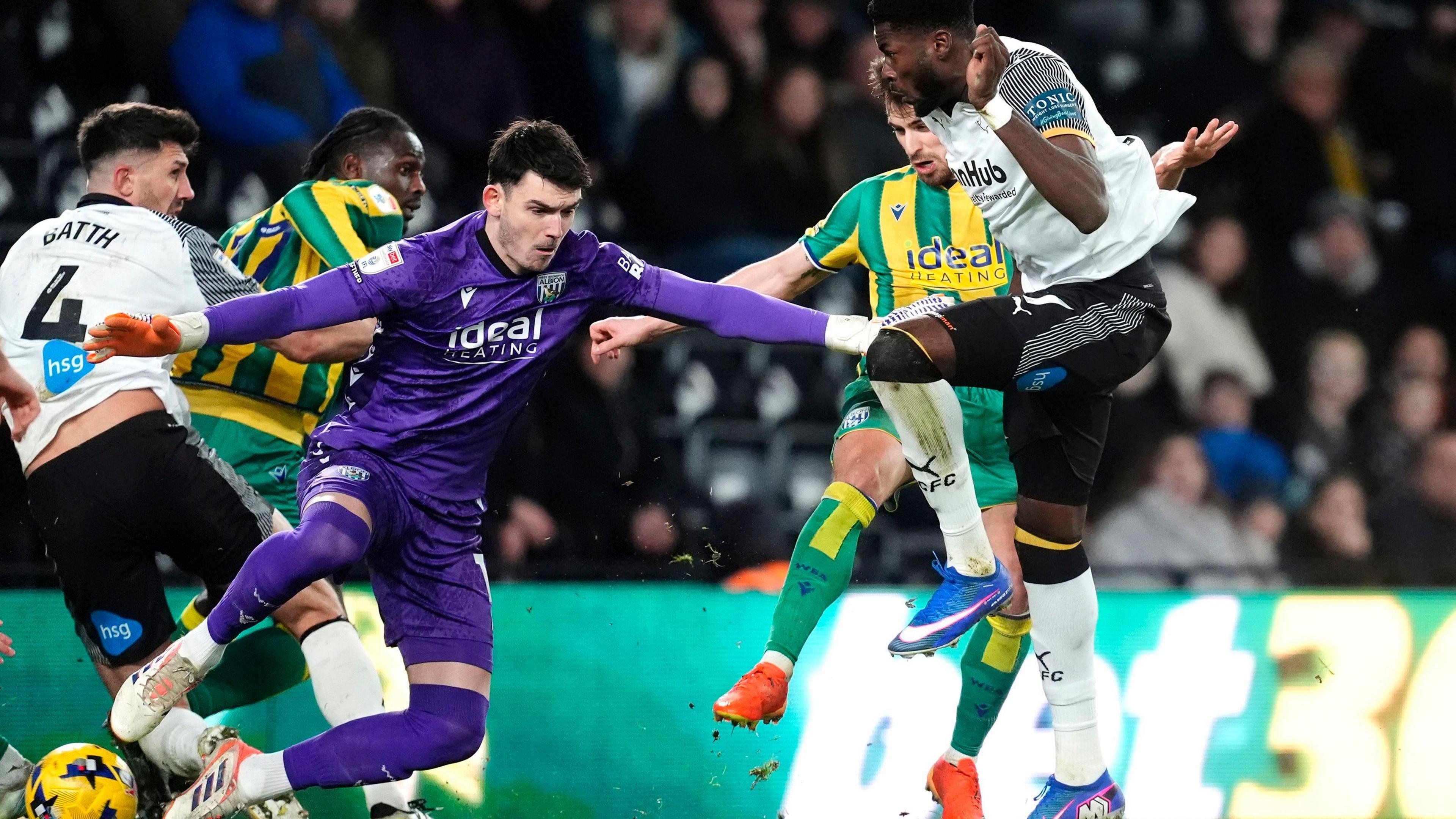 Patrick Agyemang (right) prods his goal home for Derby as West Bromwich Albion goalkeeper Max O'Leary spreads himself wide among a scrum of bodies to try and make a save