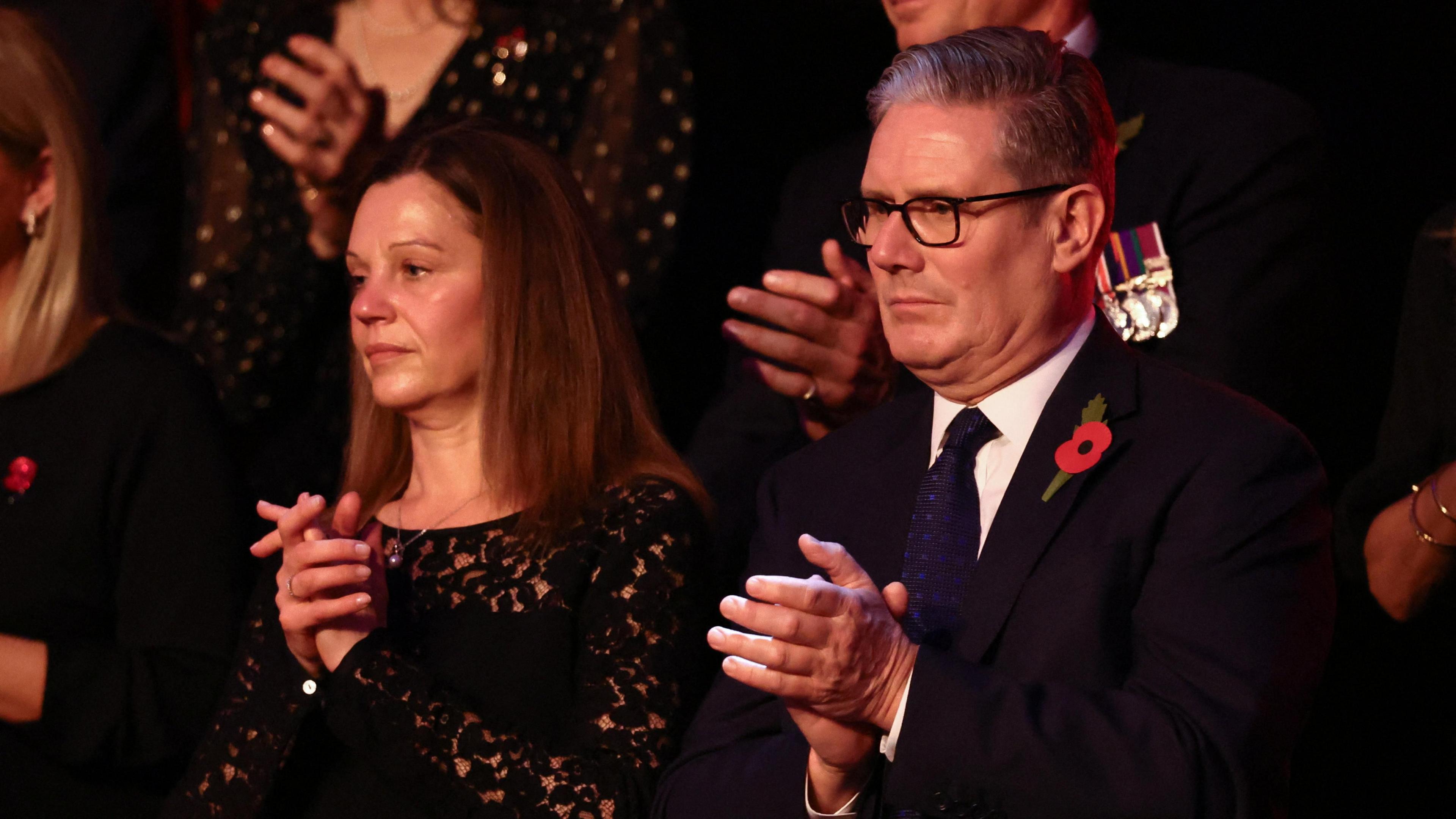 Sir Keir and Victoria Starmer both wear black and each wear a poppy at the remembrance event.