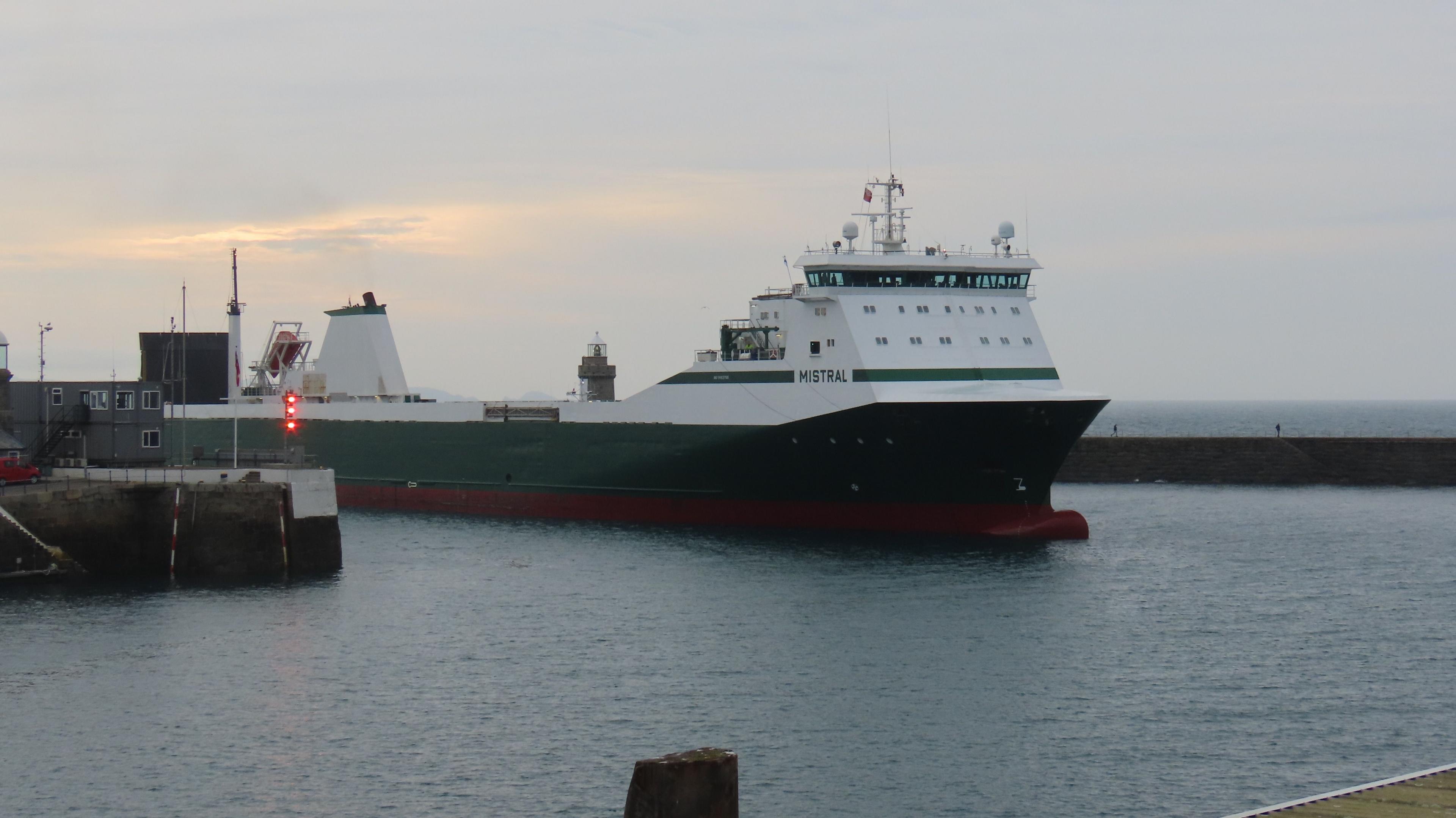 A long green ship with a white top and the word Mistral on the side arriving in St Peter Port Harbour. 