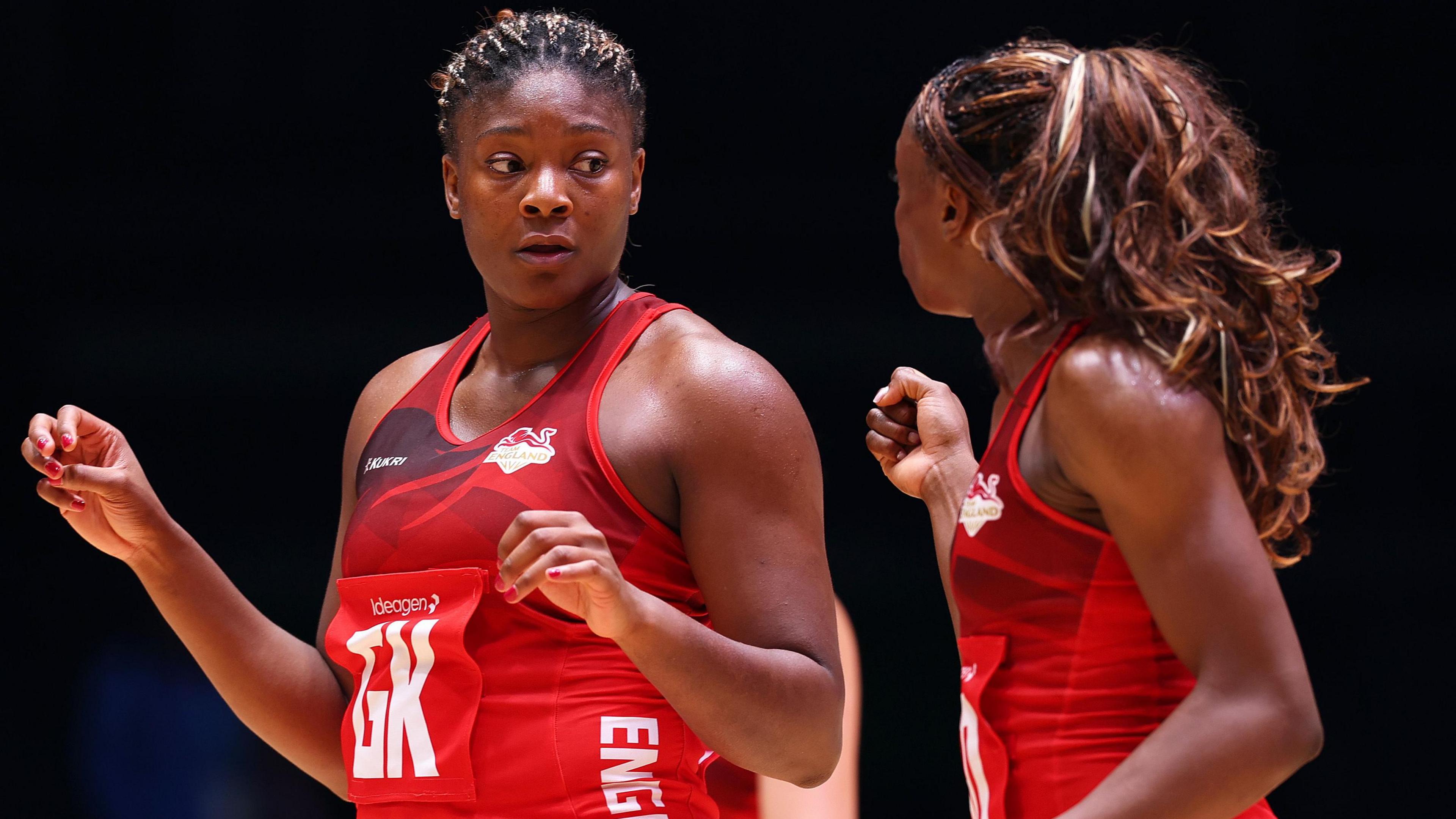 Halimat Adio and Funmi Fadoju, wearing England's red netball jersey, talk to each other during the win over South Africa