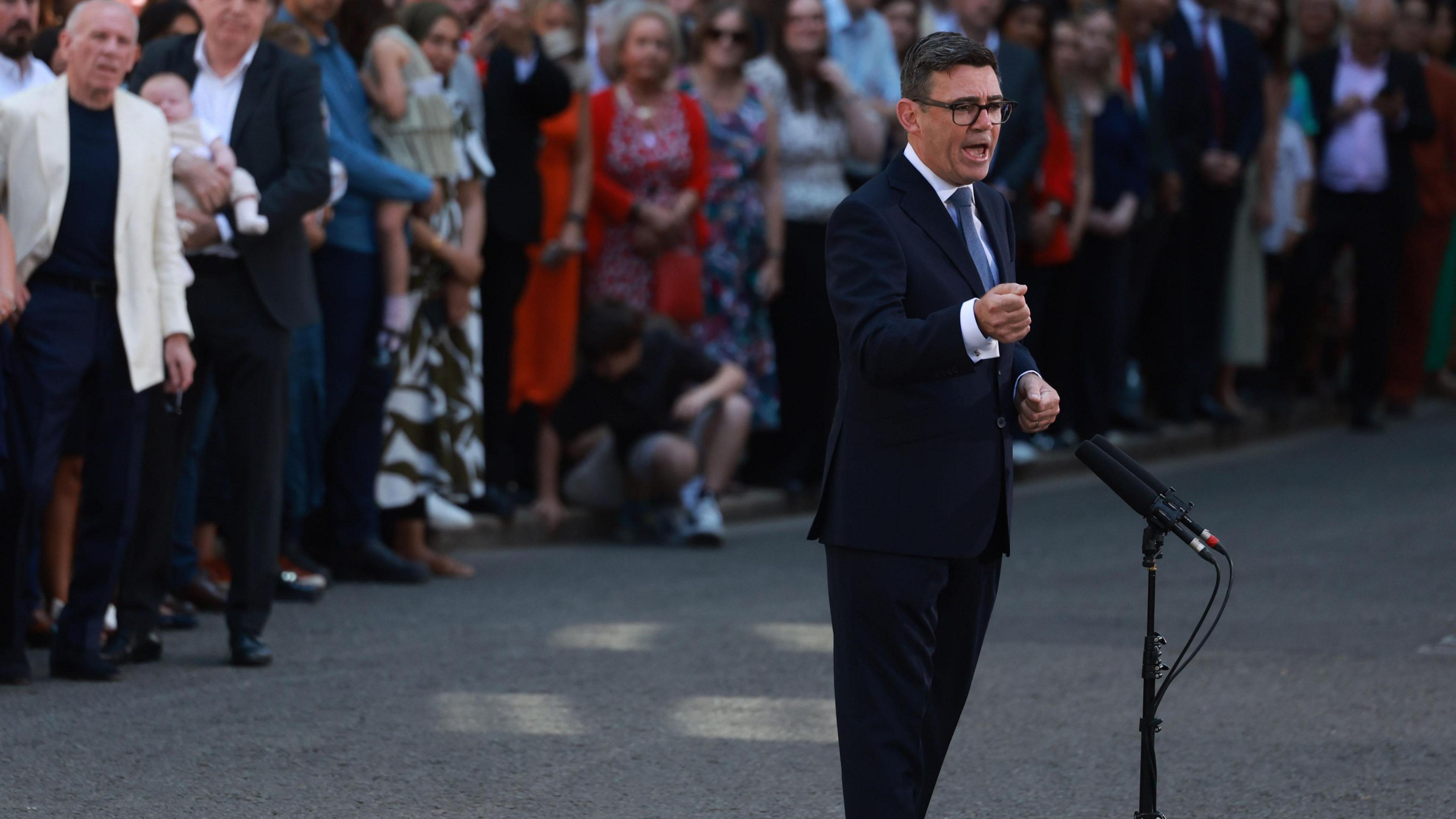 Andy Burnham makes a speech in Downing Street with microphones in the street