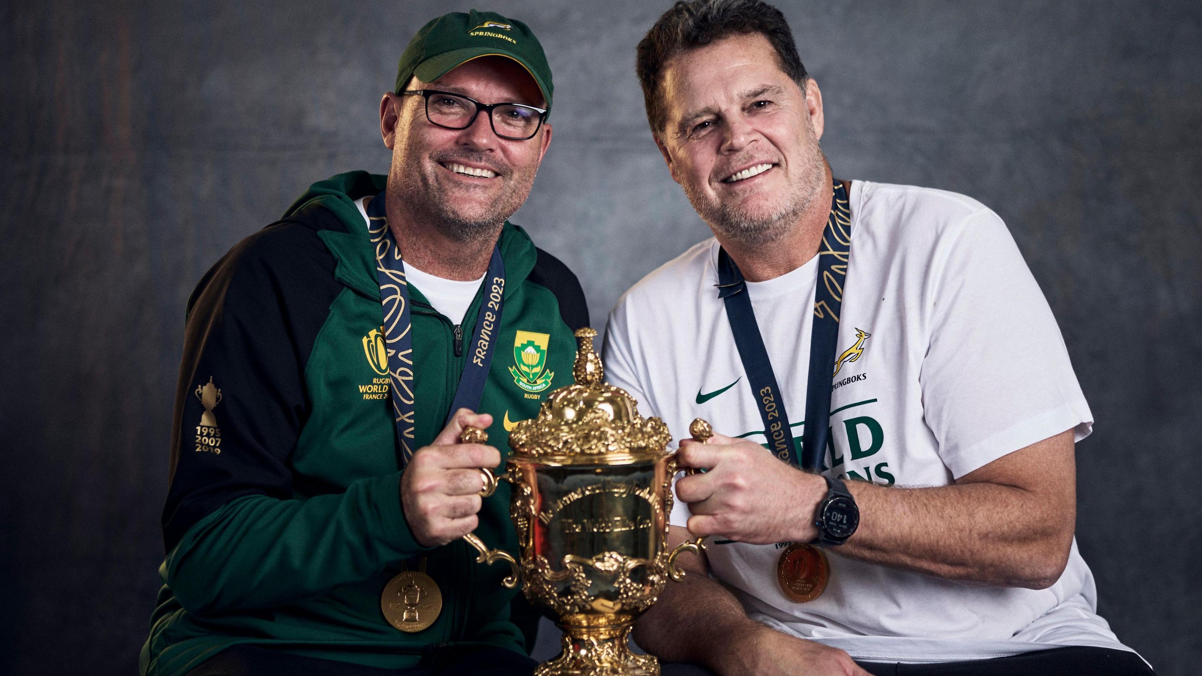 South Africa coaches Jacques Nienaber and Rassie Erasmus pose with the Webb Ellis Cup 