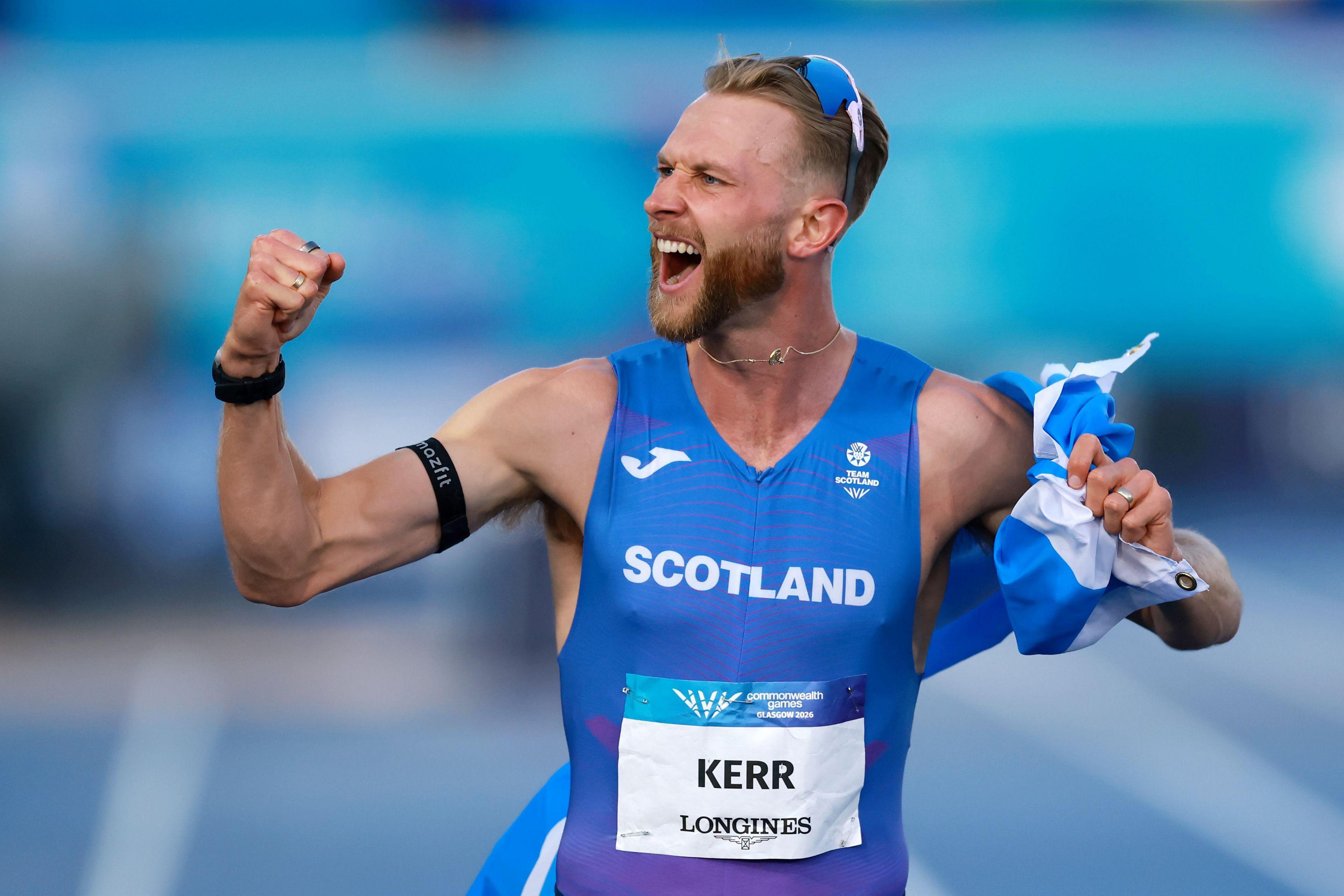 Mile world record holder Josh Kerr celebrates his Commonwealth title. He looks very happy.