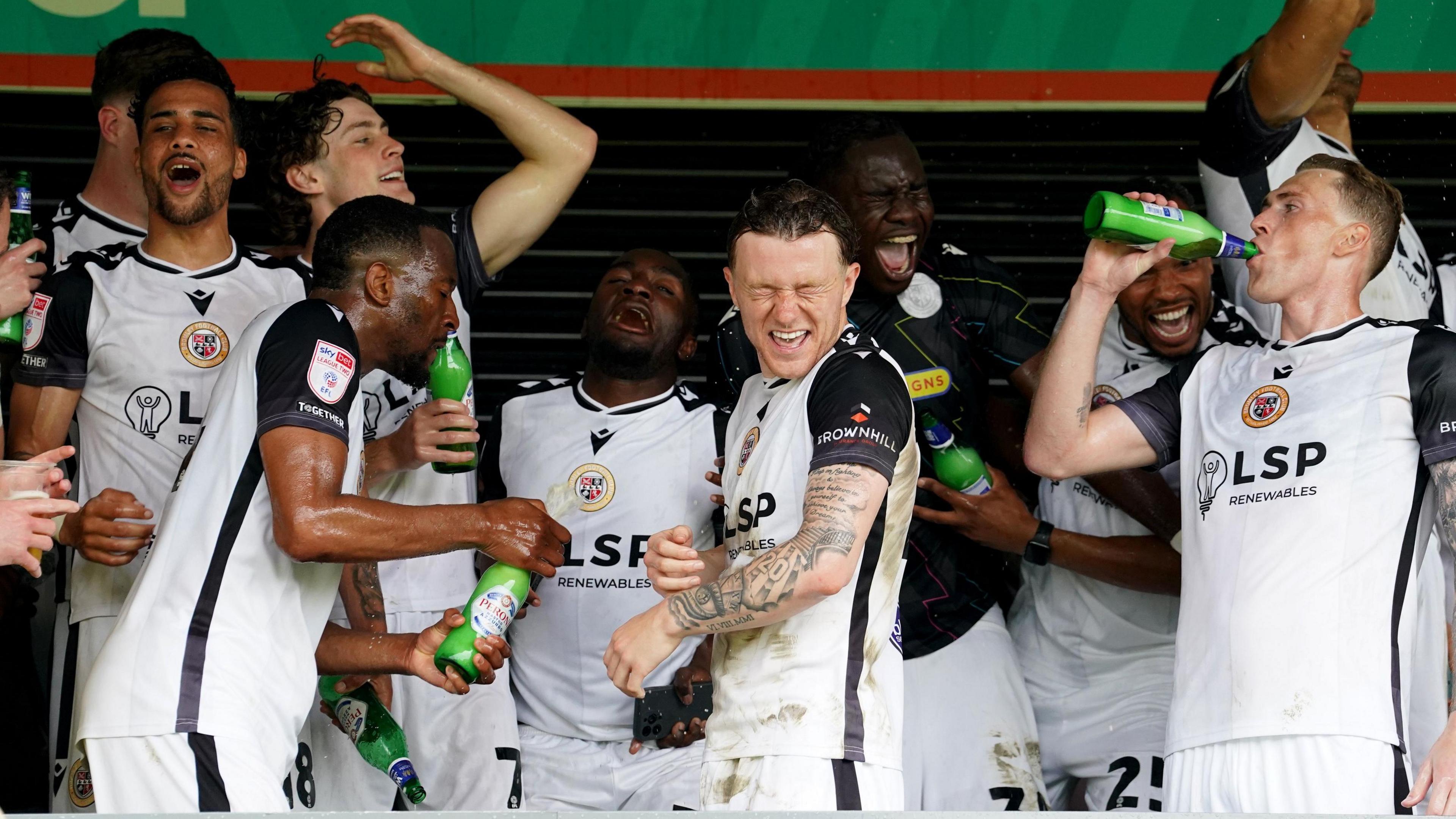 Bromley players celebrate after the final game of the season