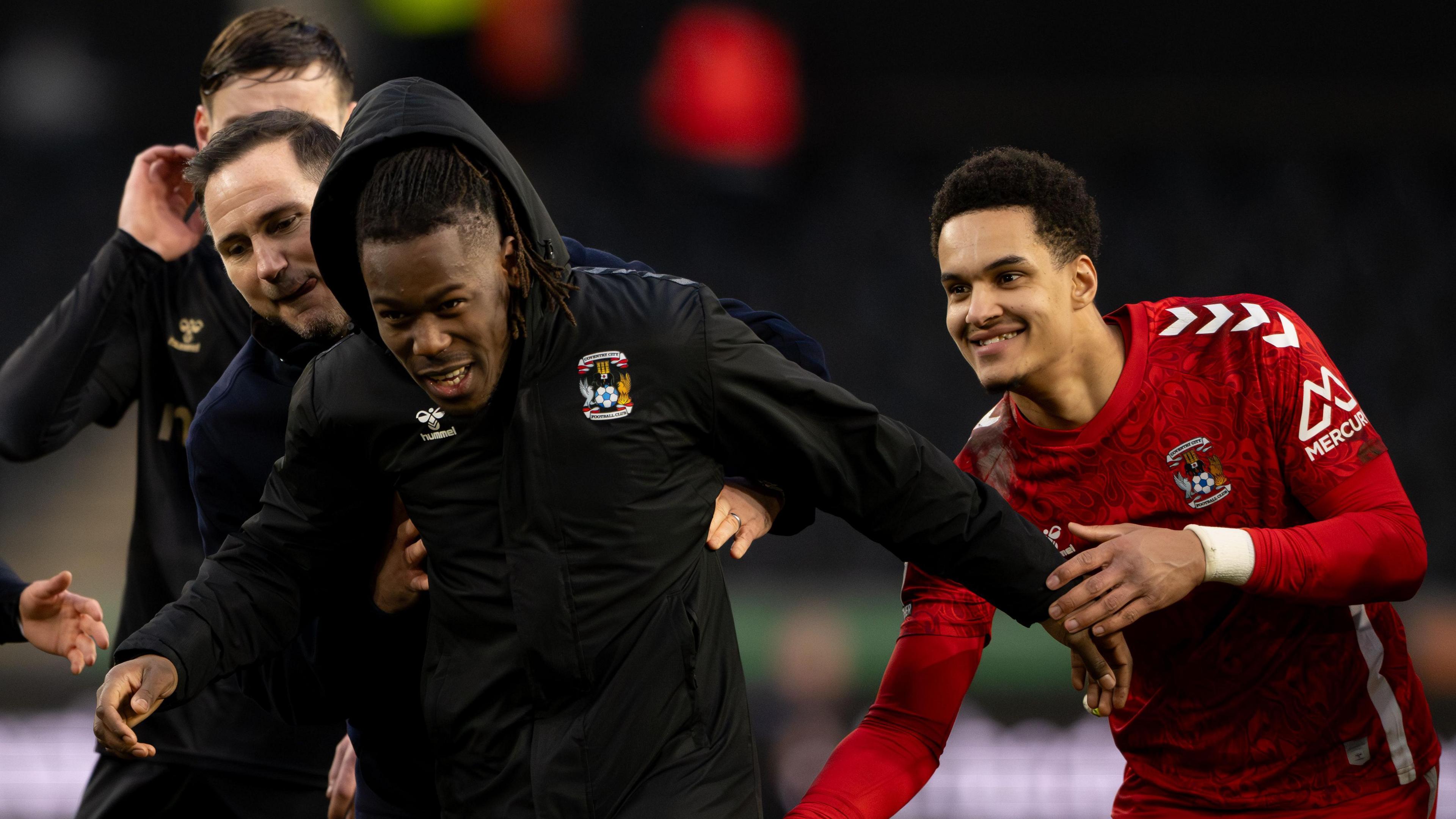 Coventry boss Frank Lampard celebrates victory at Swansea with scorer Brandon Thomas-Asante and keeper Oliver Dovin (right)