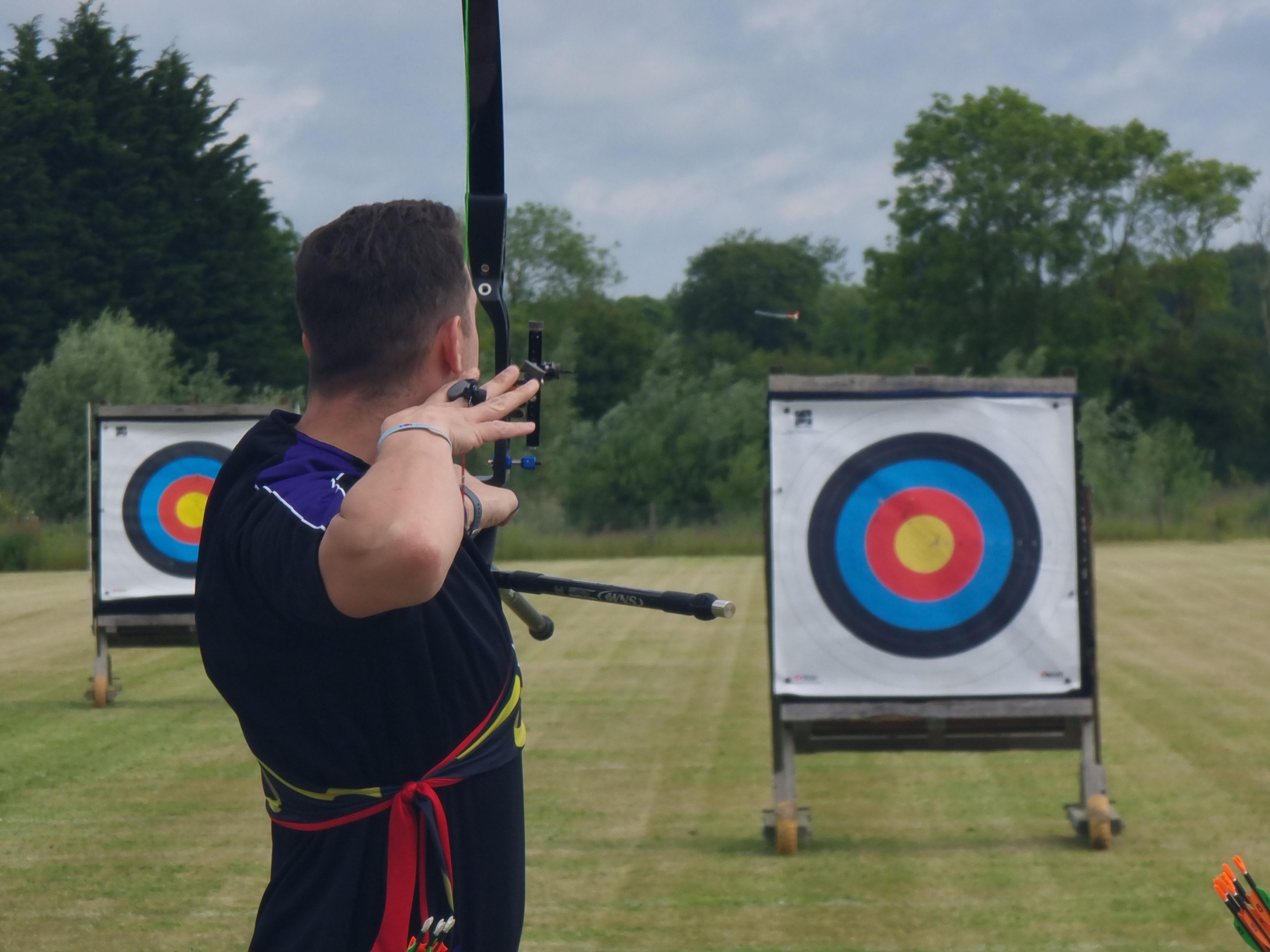 Richard Davies shooting an arrow at a target