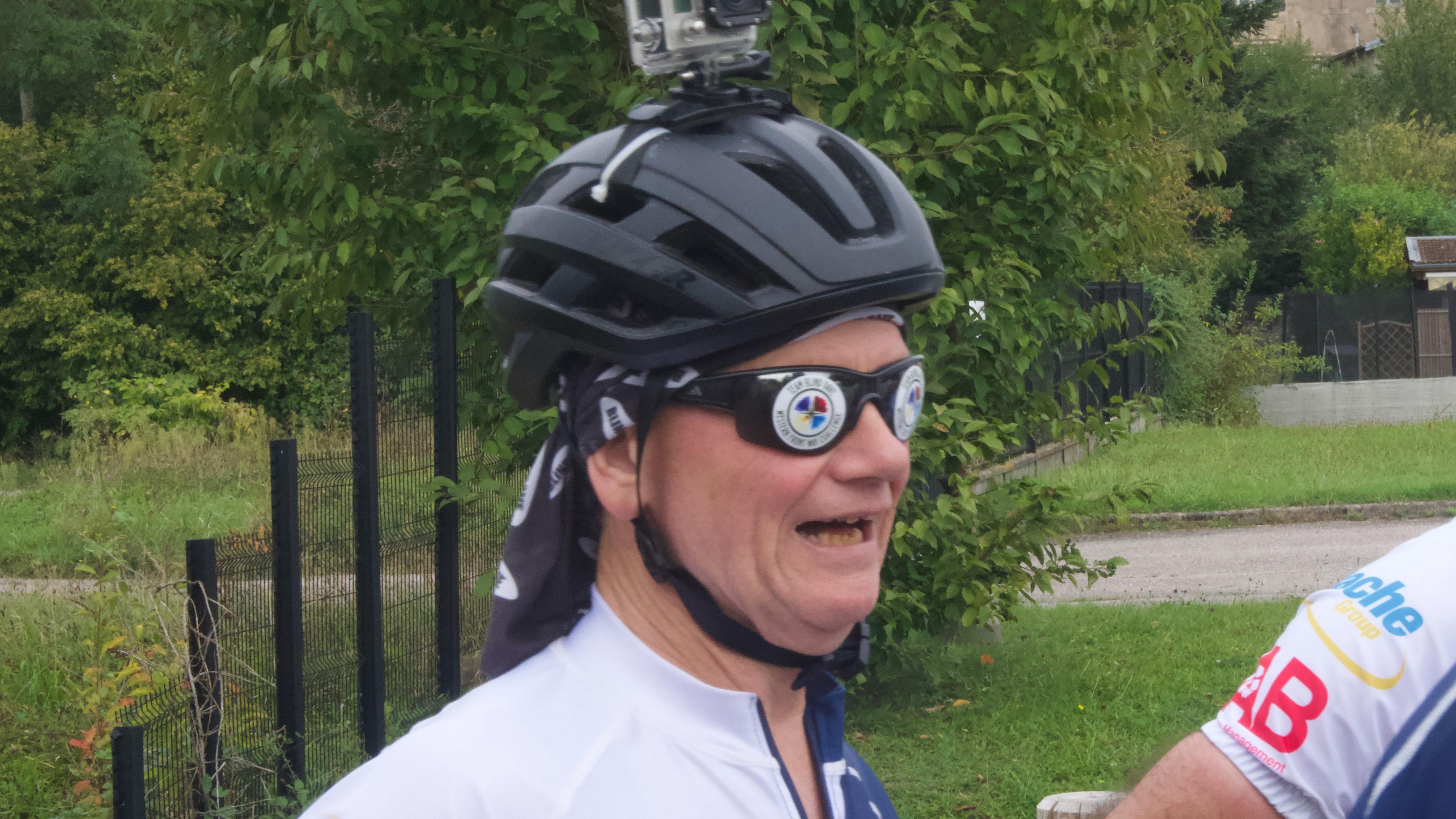 A man with a sunglasses and cycle helmet with camera on top