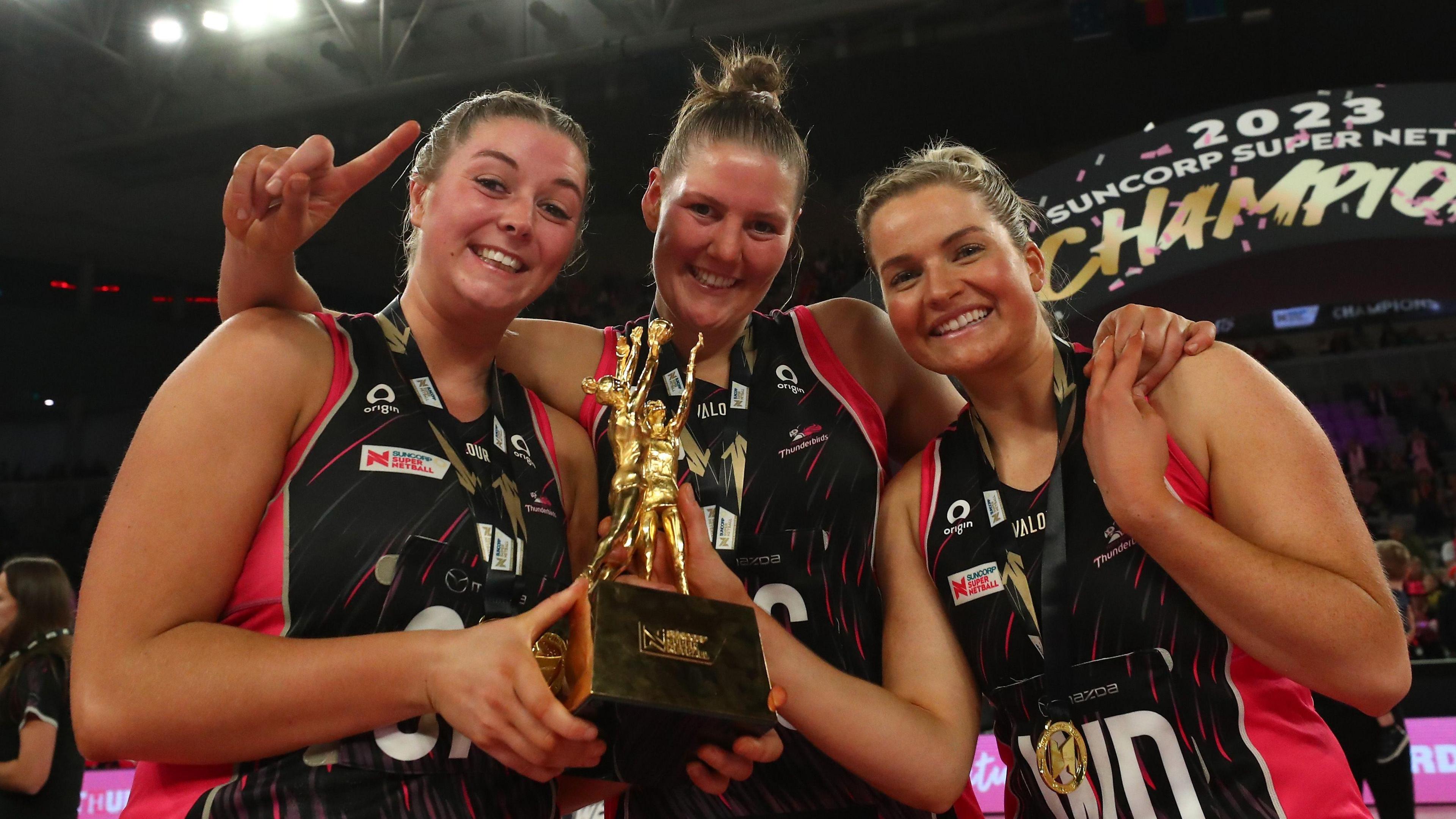 Eleanor Cardwell, Lucy Austin and Maisie Nankivell of the Thunderbirds celebrate victory with the trophy after the 2023 Super Netball Grand Final match between Adelaide Thunderbirds and NSW Swifts