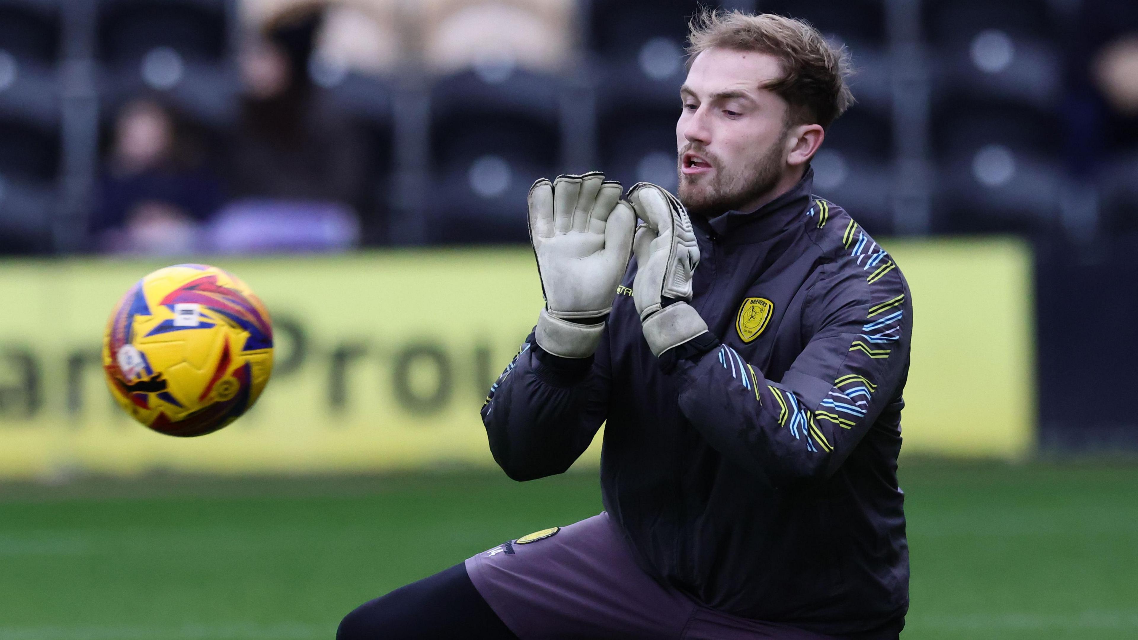 Harry Isted warms up for a game by practicing saving a shot