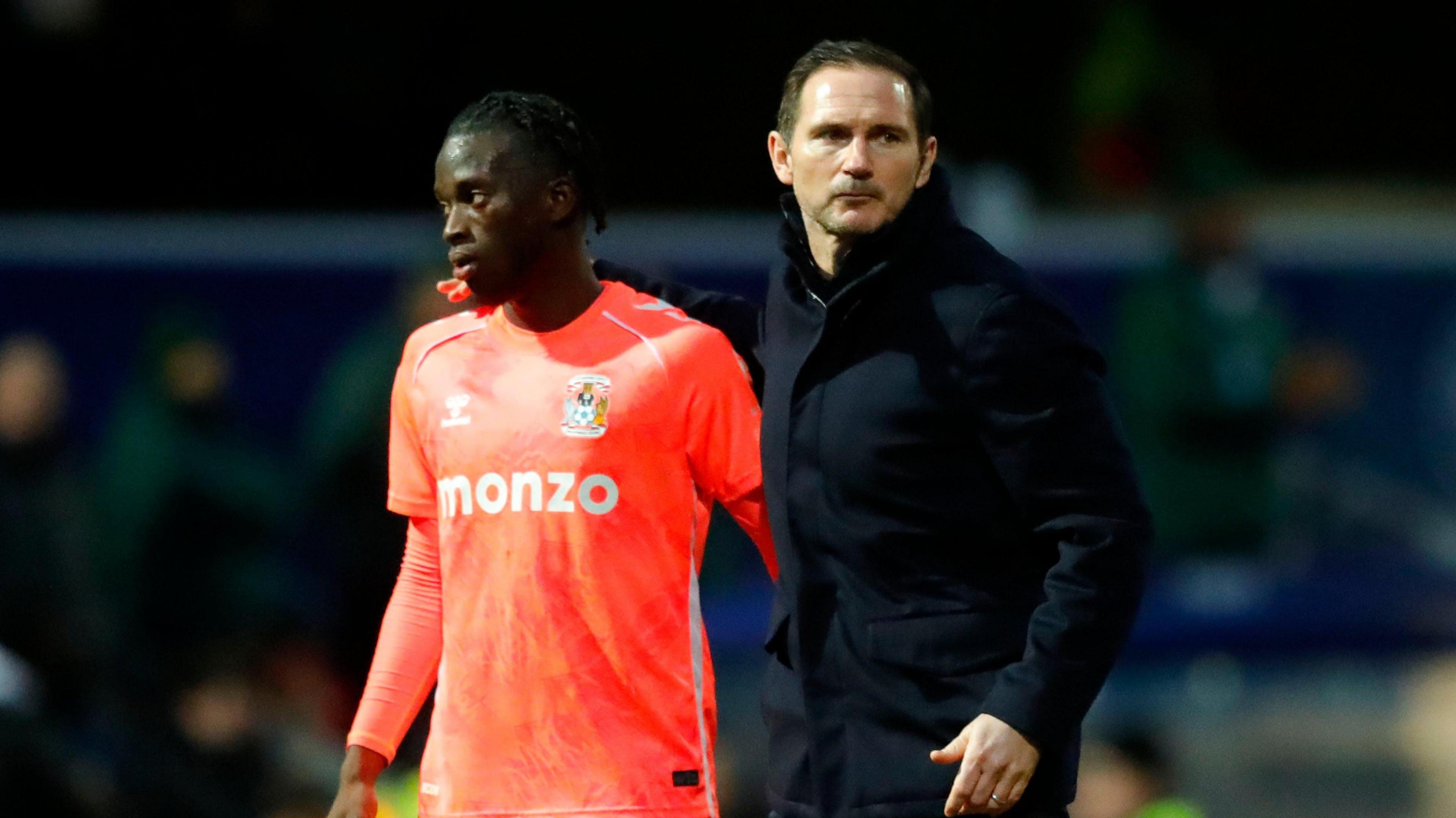 Frank Lampard (right) looking stern-faced and with his arm on the shoulder of Coventry player Romain Esse