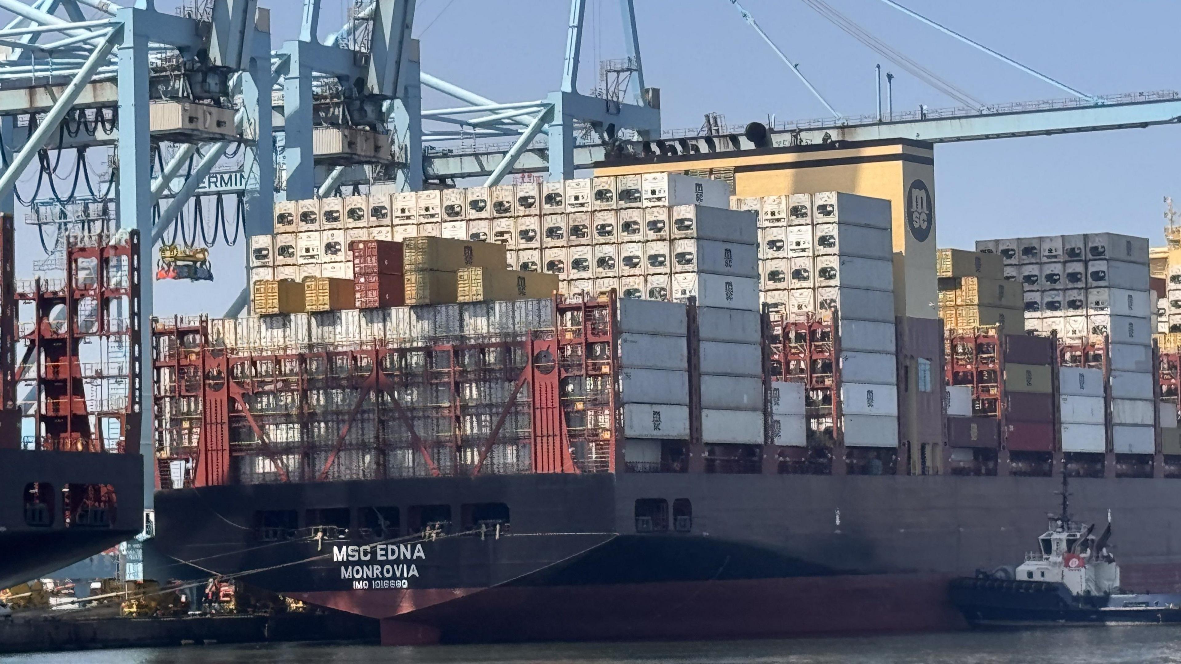A tug alongside a large container ship at Rotterdam