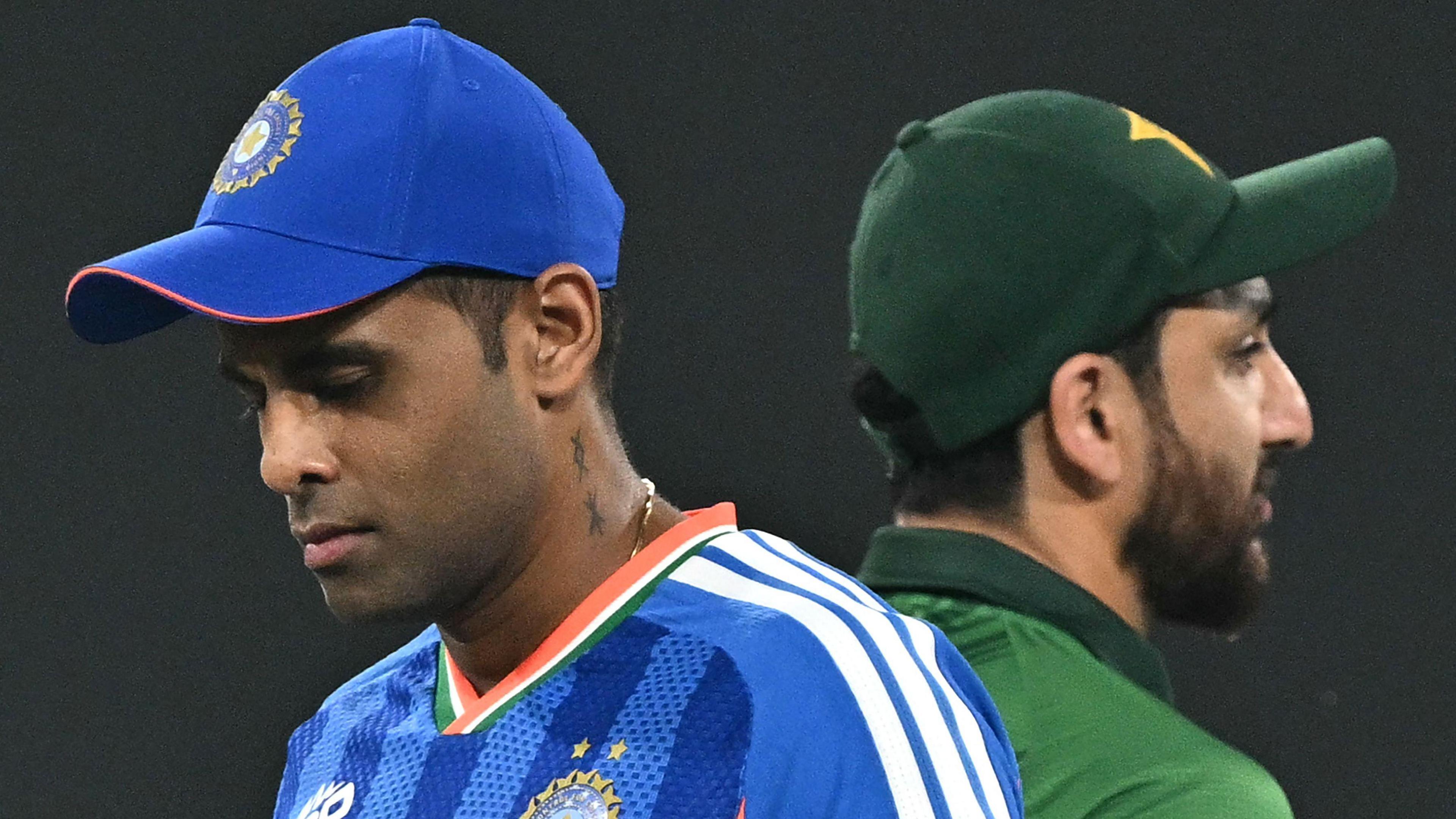 India's captain Suryakumar Yadav (L) walks past his Pakistan counterpart Salman Agha after the toss before the start of the 2026 ICC Men's T20 Cricket World Cup group stage match between India and Pakistan at the R Premadasa Stadium in Colombo 