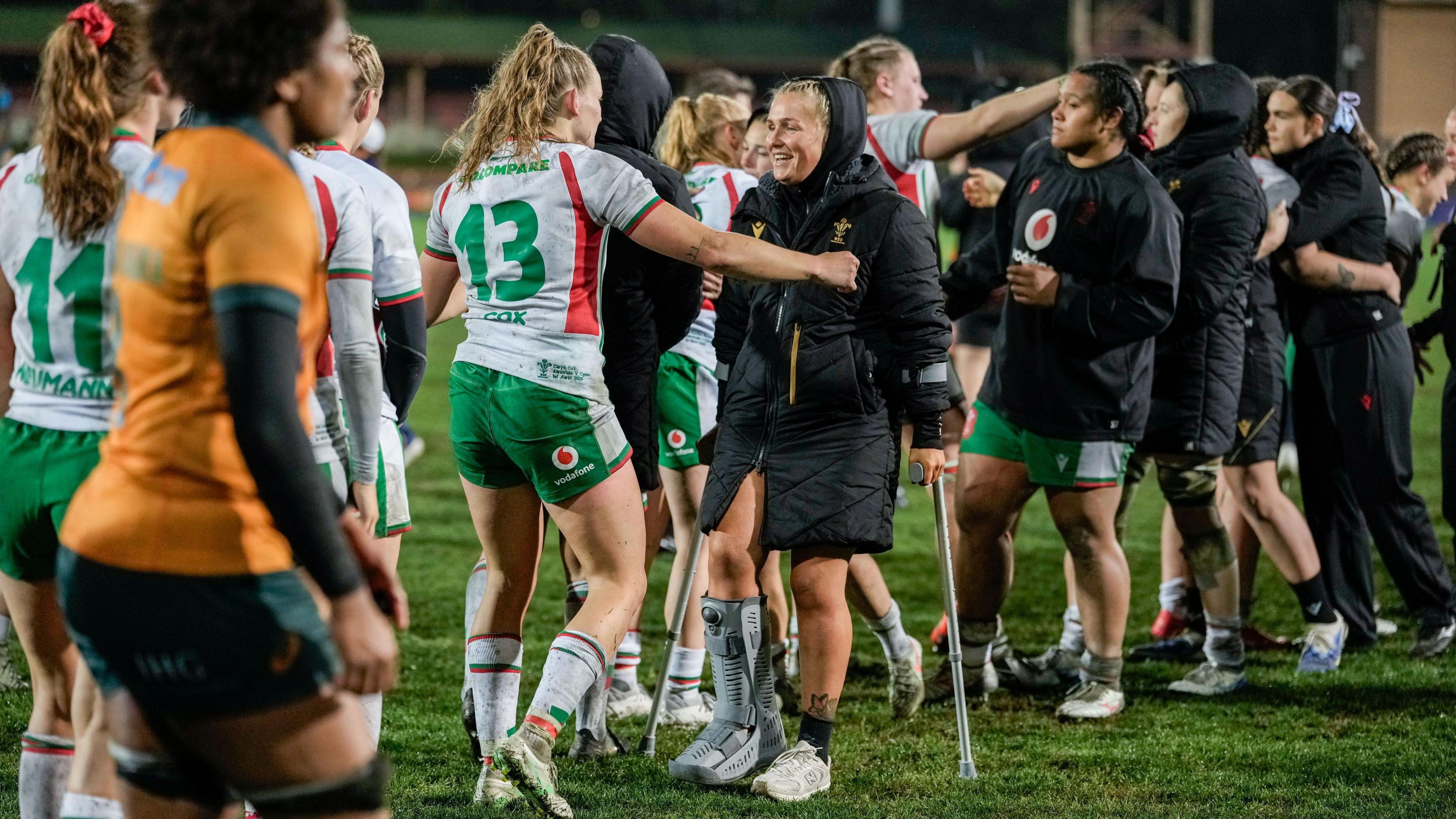 Alex Callender returned to nan section wearing a footwear and connected crutches