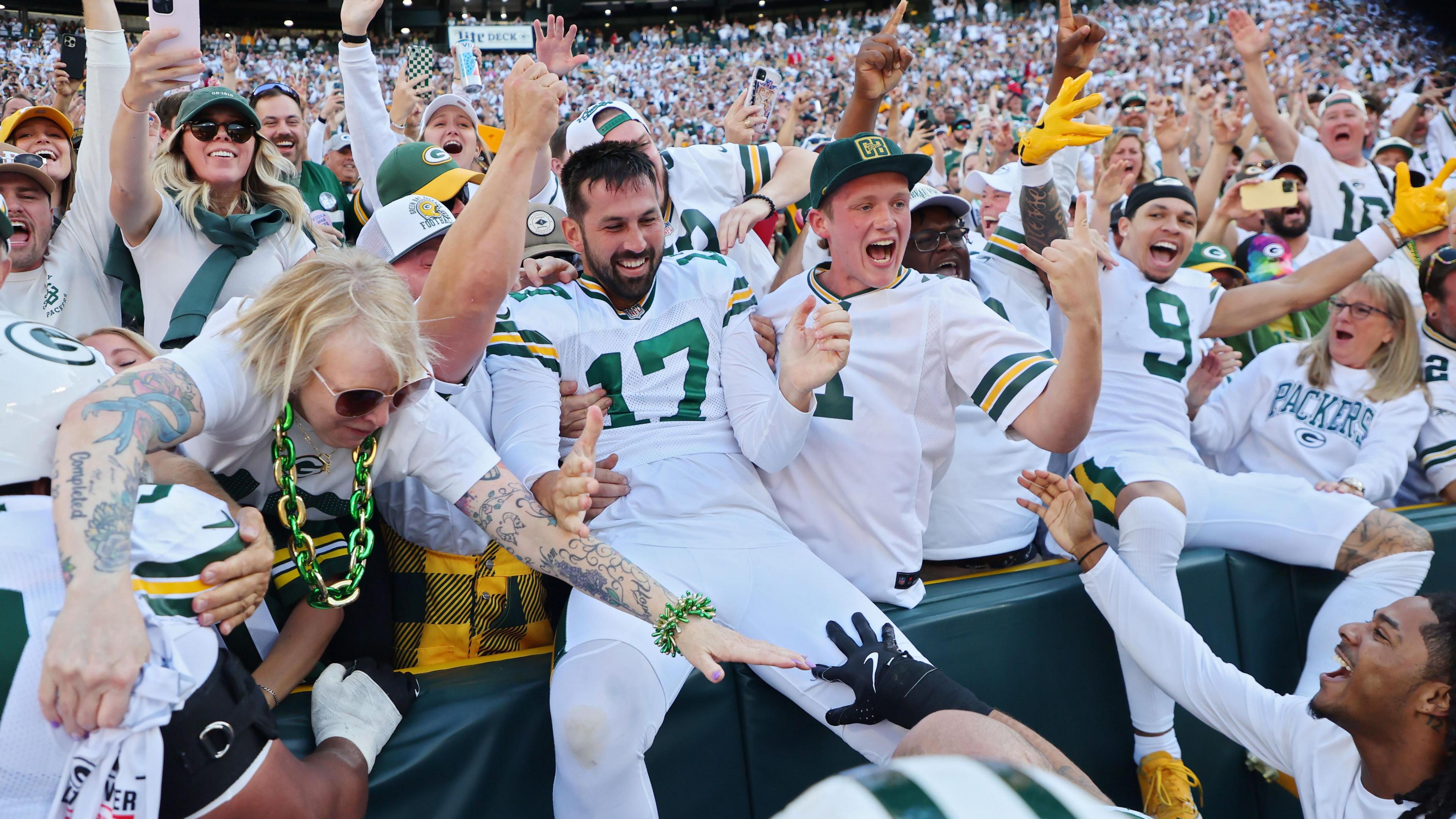 Green Bay Packers kicker Brandon McManus jumps into the crowd at Lambeau Field after booting the game-winning field goal