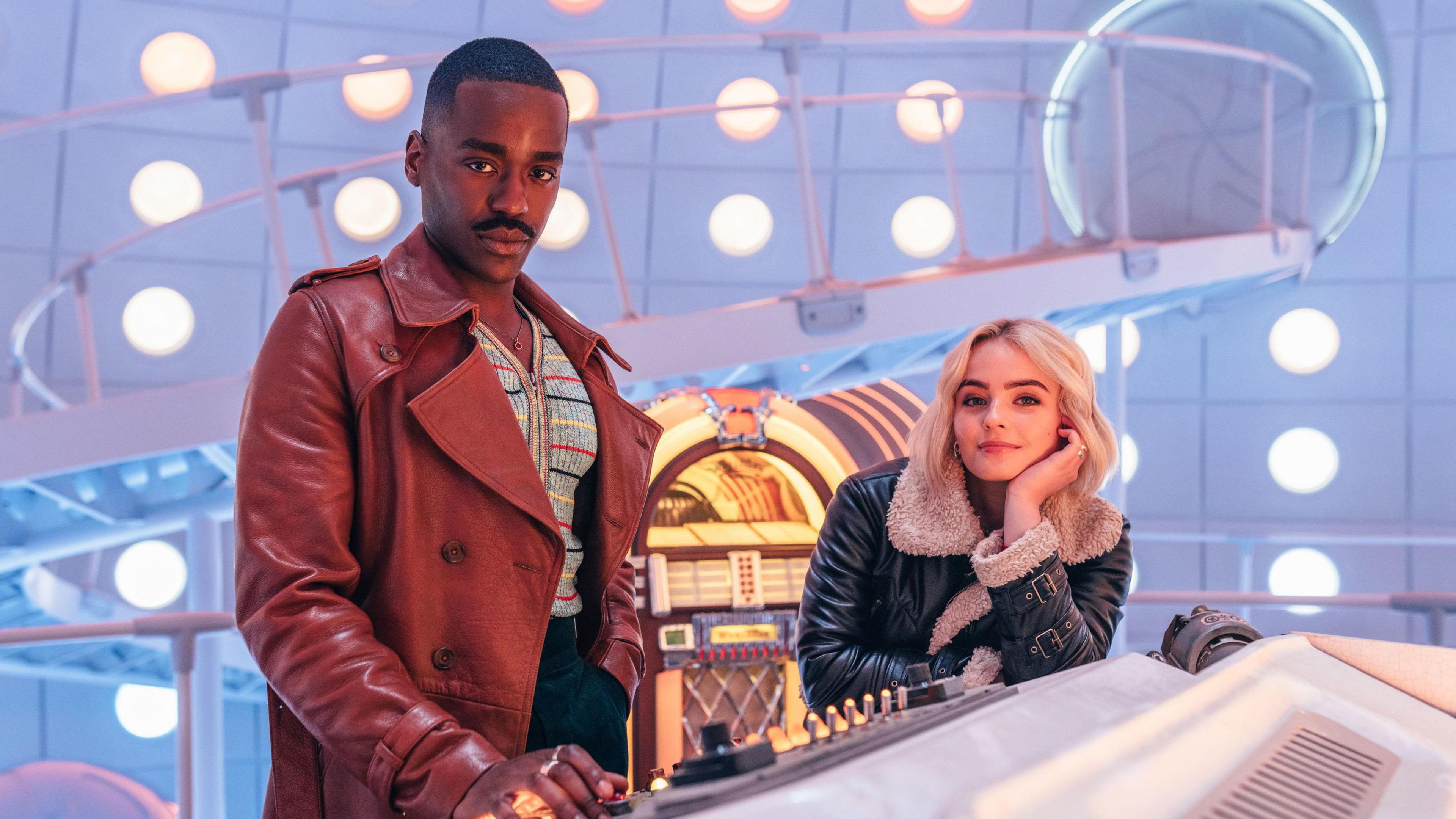 The Doctor and Ruby Sunday, from Doctor Who, inside the gleaming white Tardis at the ship's console