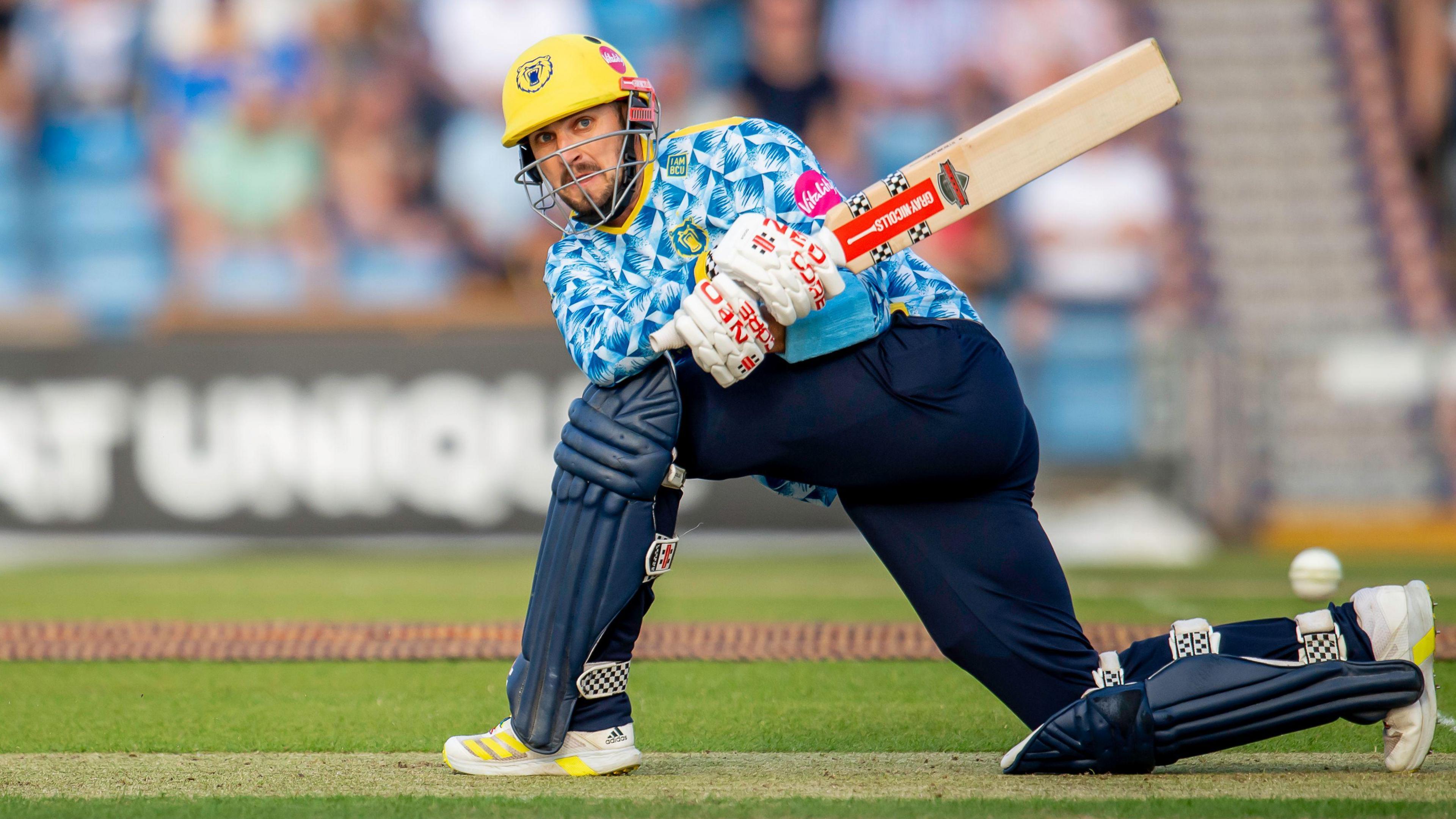 Ed Barnard goes down on one knee to sweep the ball while batting for Birmingham Bears in the T20 Blast