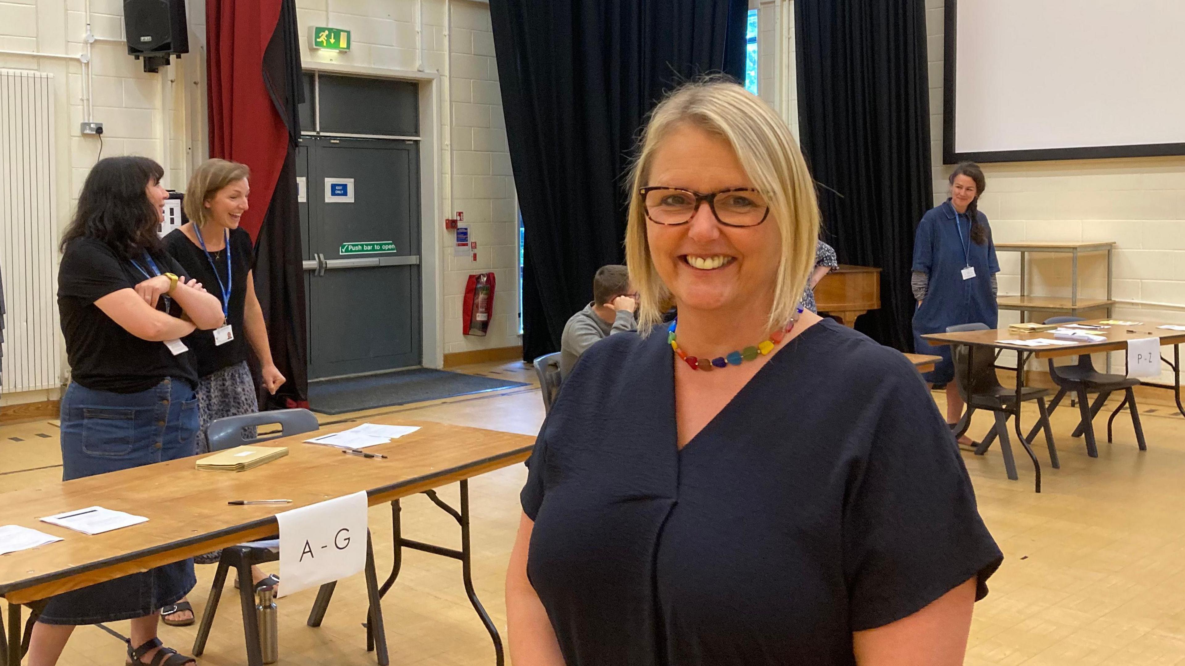 Kingsbridge Community College principal Tina Graham smiling as pupils turn up to collect A-level results.