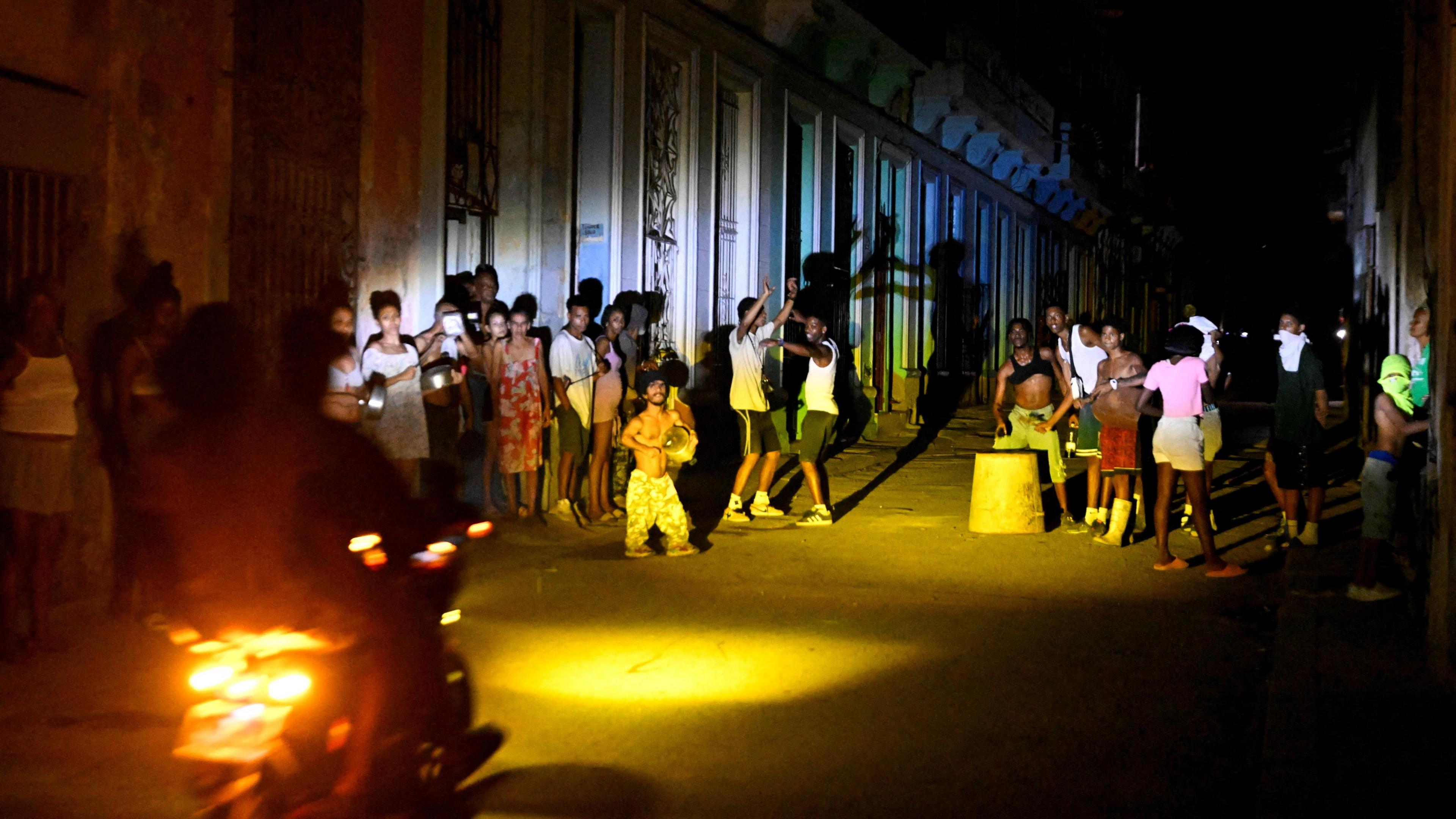 People gather on a street during a blackout as Cuba's national electric grid collapsed, according to the country's grid operator, 16 Mar 2026