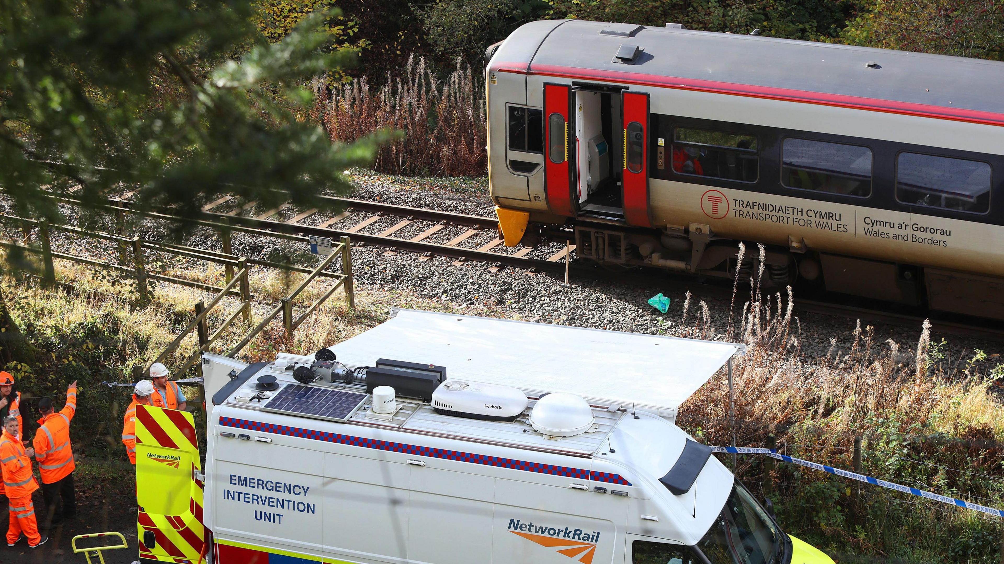 A Network Rail Emergency Intervention Unit van attends the scene of a train crash.