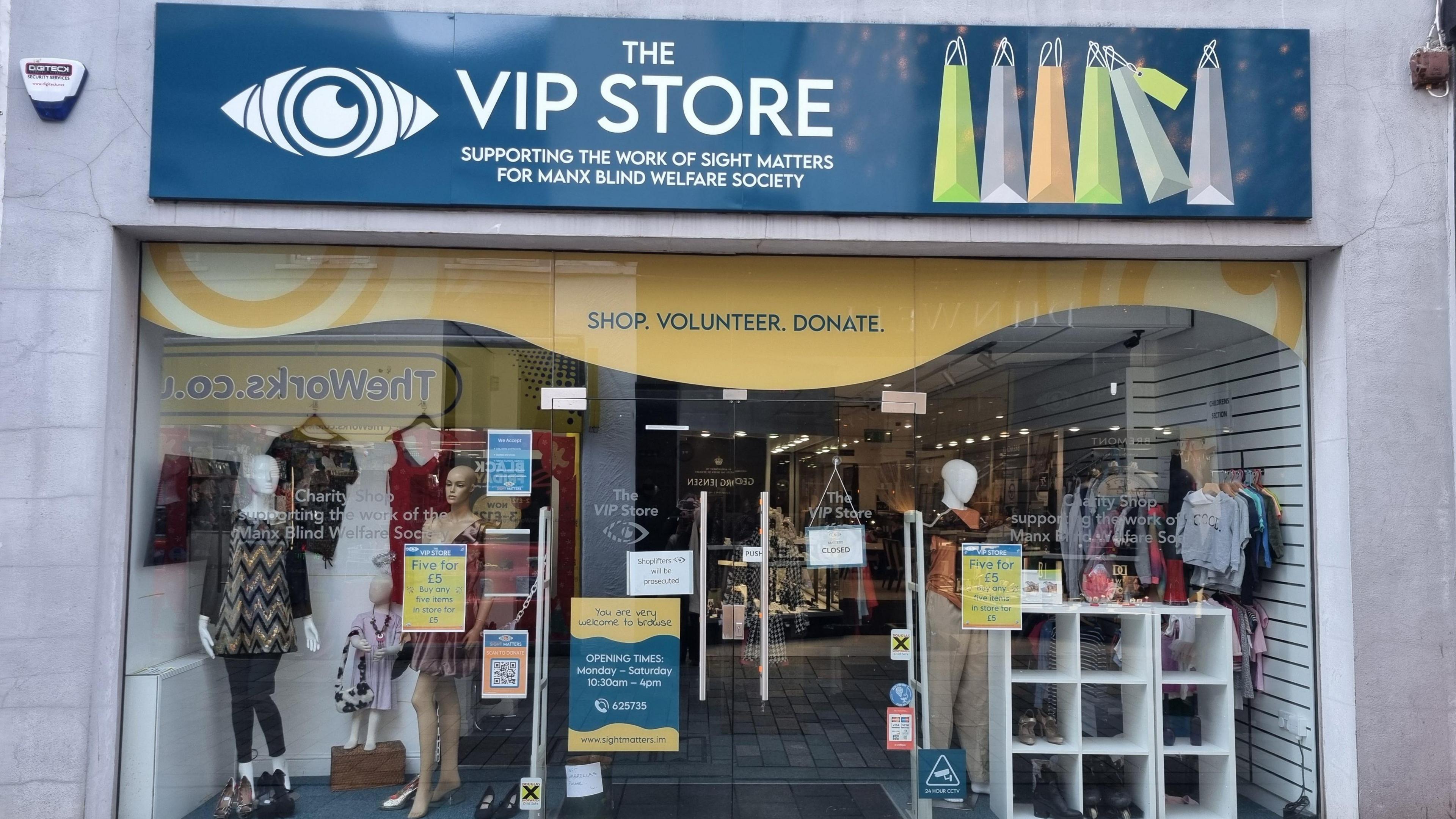 The VIP Store charity shop in Douglas has a large window display with clothes displayed on mannequins. There are lilac walls on both sides of the shop, while a sign above its front door says the store is "supporting the work of Sight Matters for Manx Blind Welfare Society".