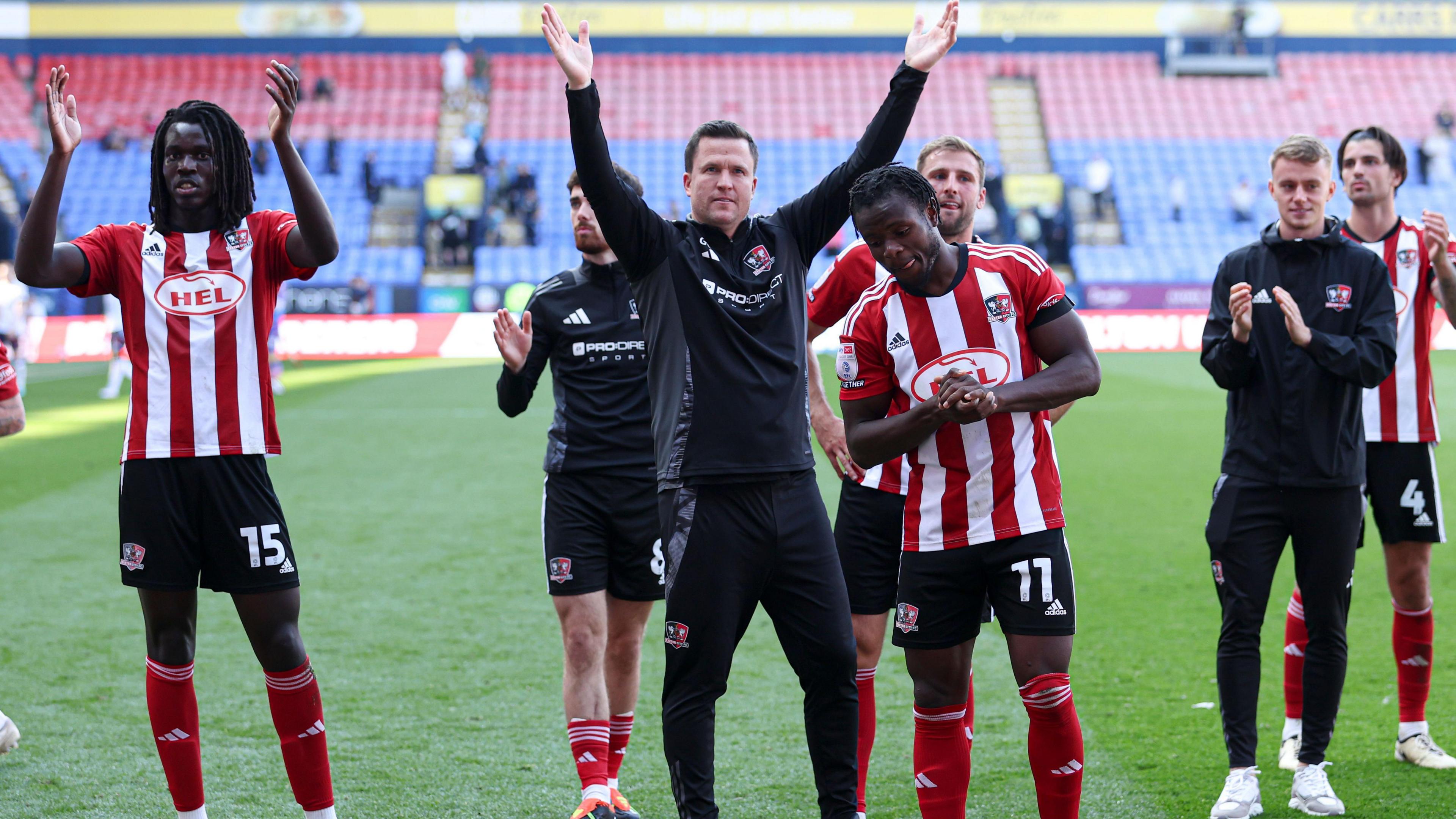 Gary Caldwell and Exeter players celebrate winning at Bolton