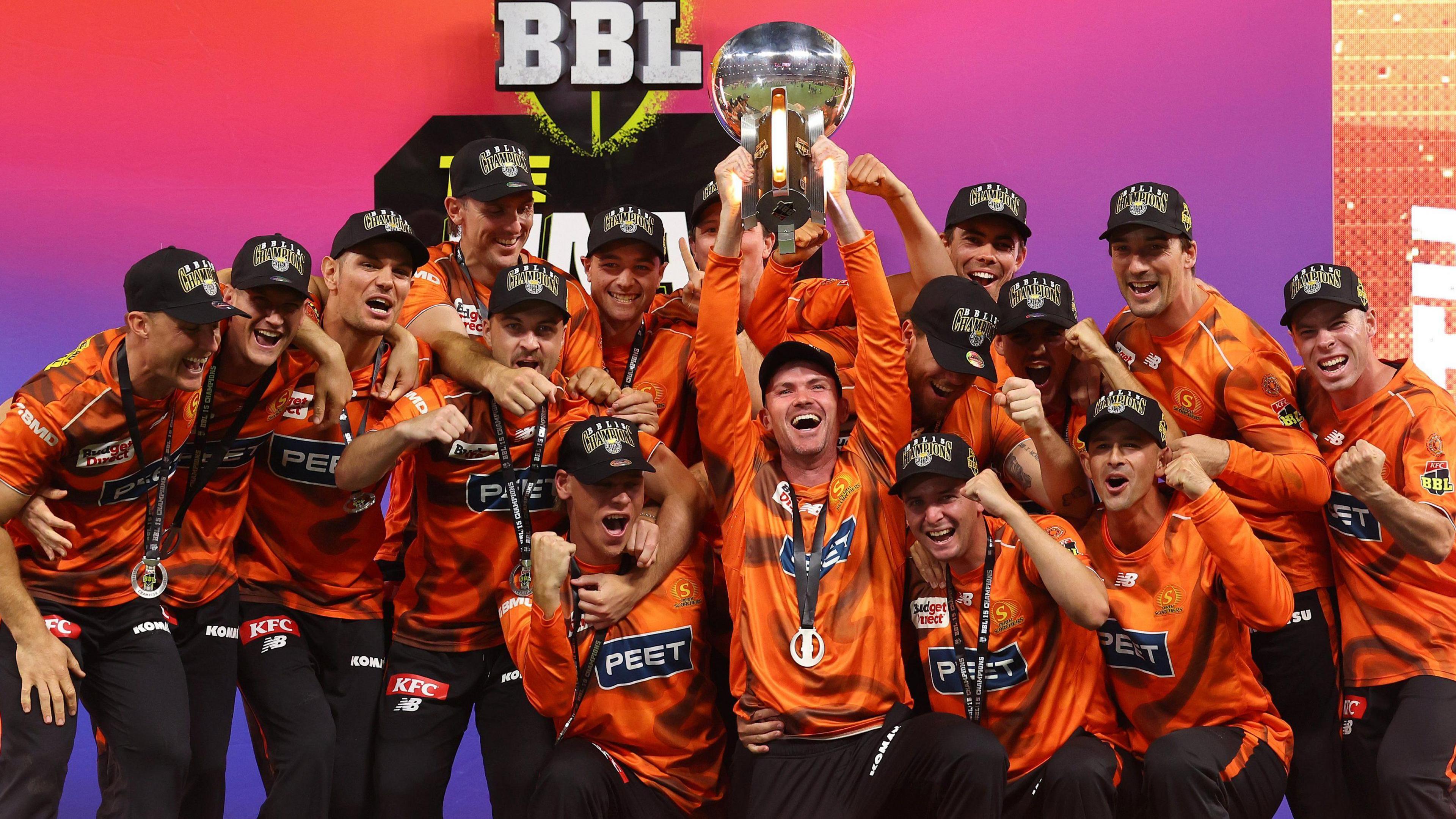 Perth Scorchers players celebrate as they lift the 2025-26 Big Bash League trophy following victory over Sydney Sixers