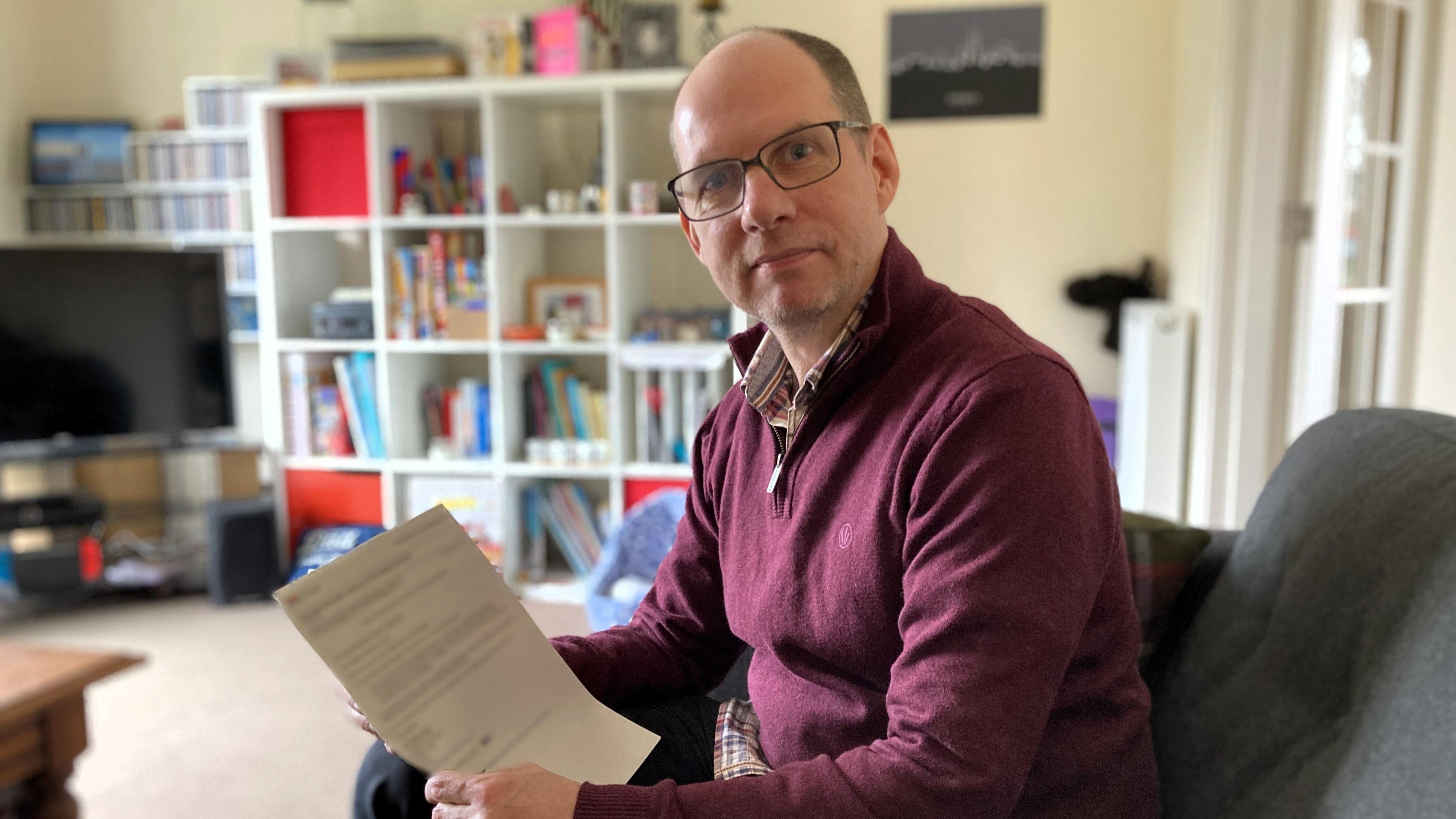 Matt Couchman holding a letter