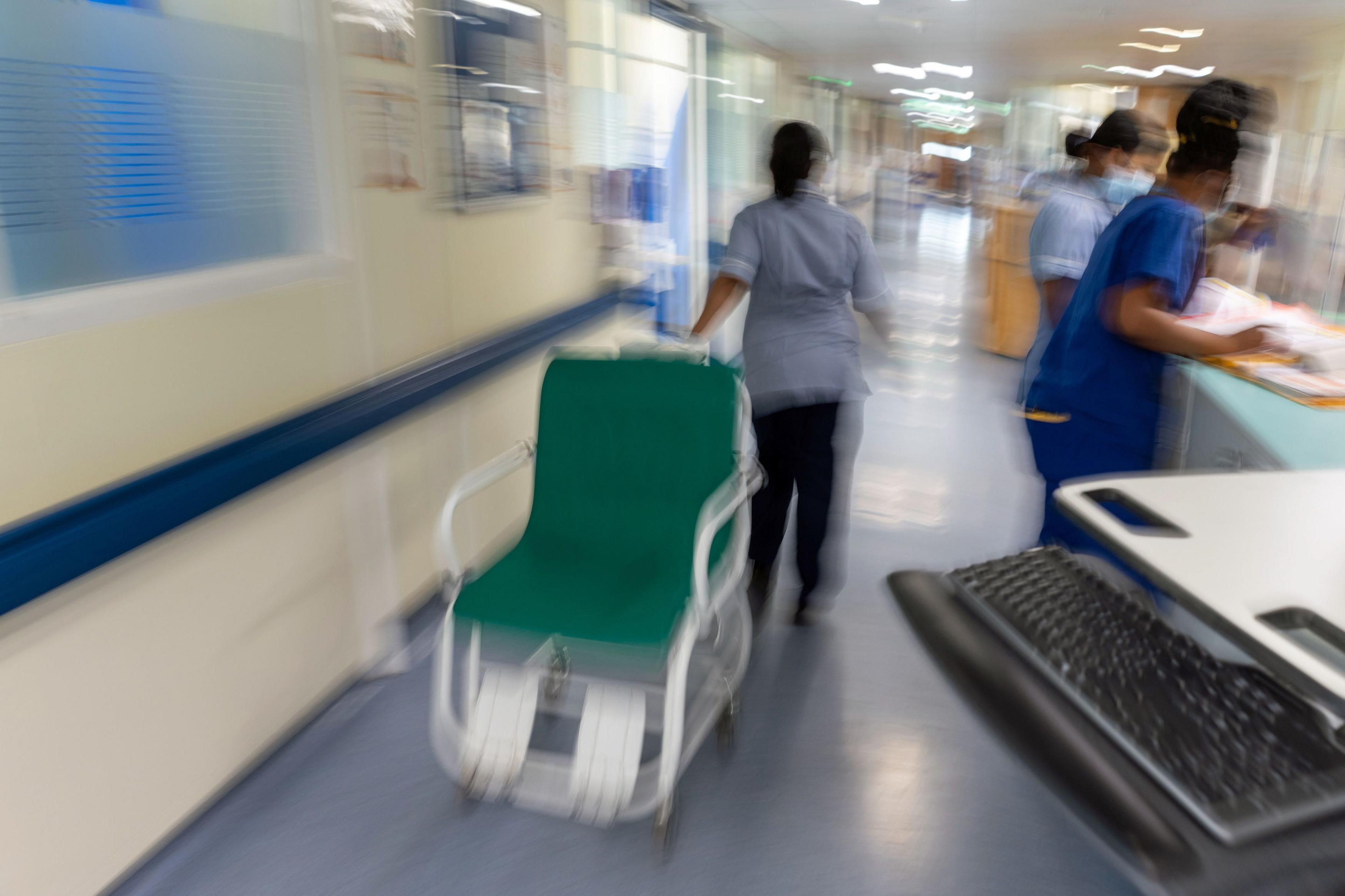 NHS ward staff hurry to care for patients