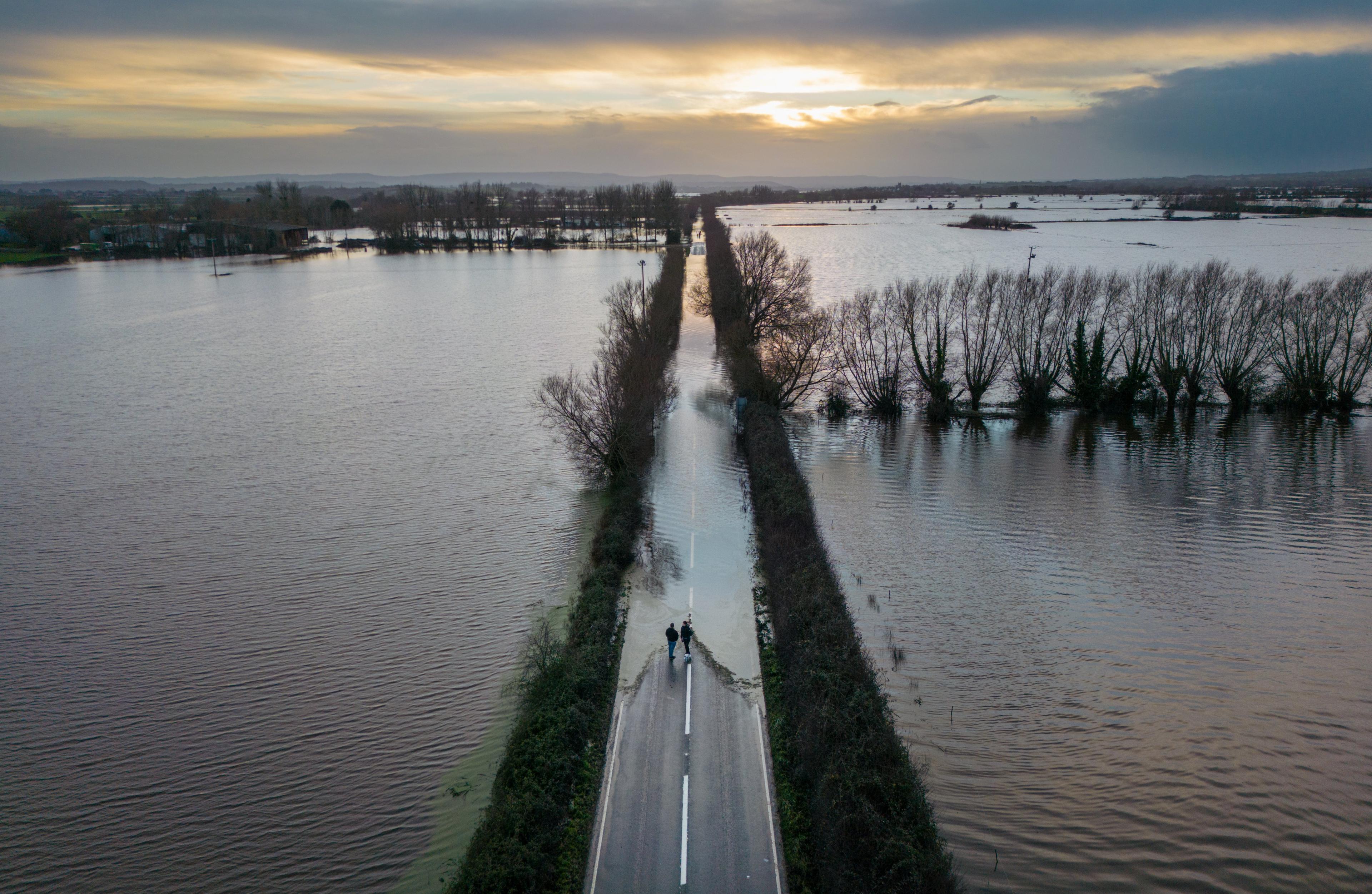 Flood water surrounds road