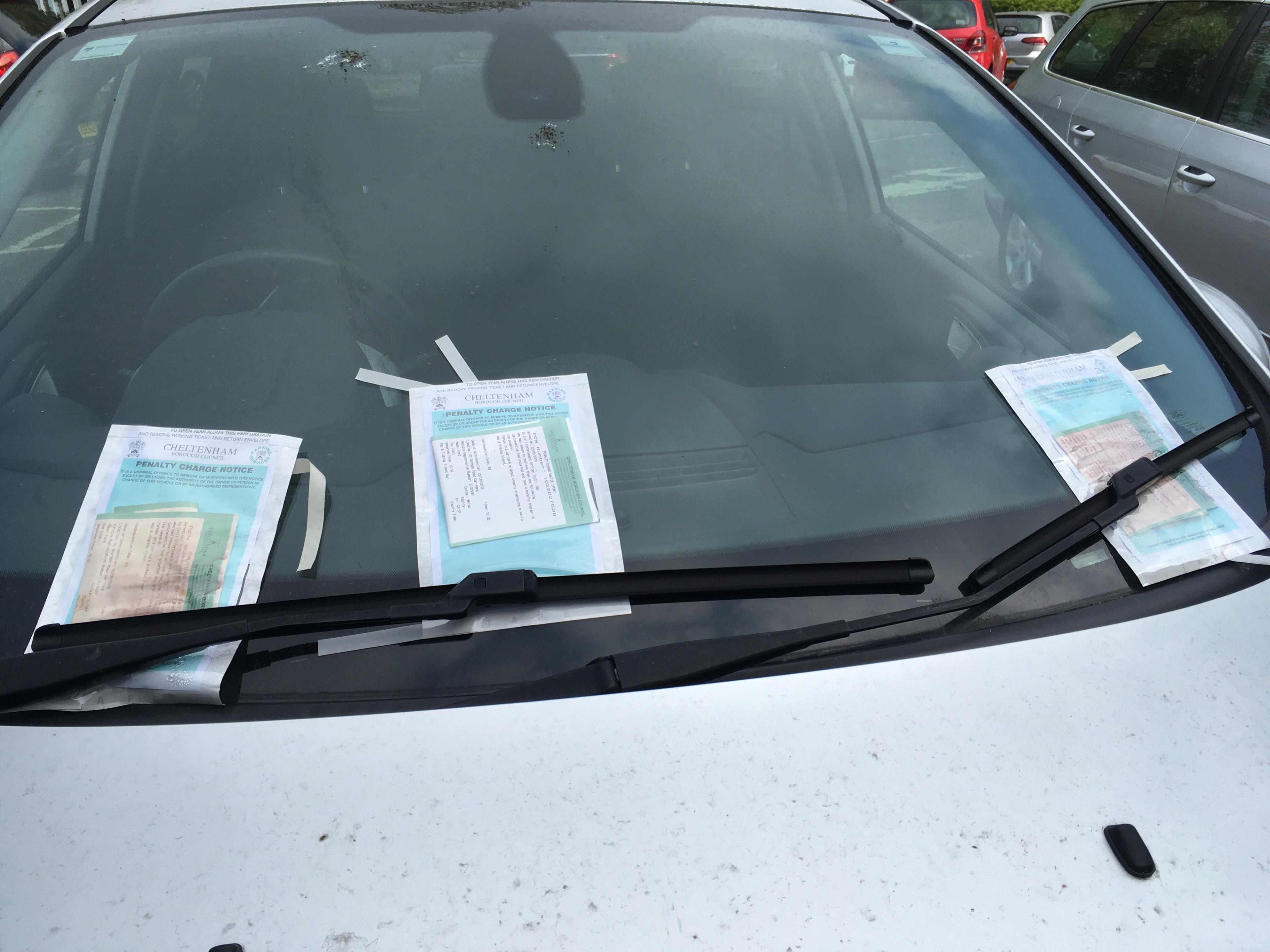 Car covered in parking tickets