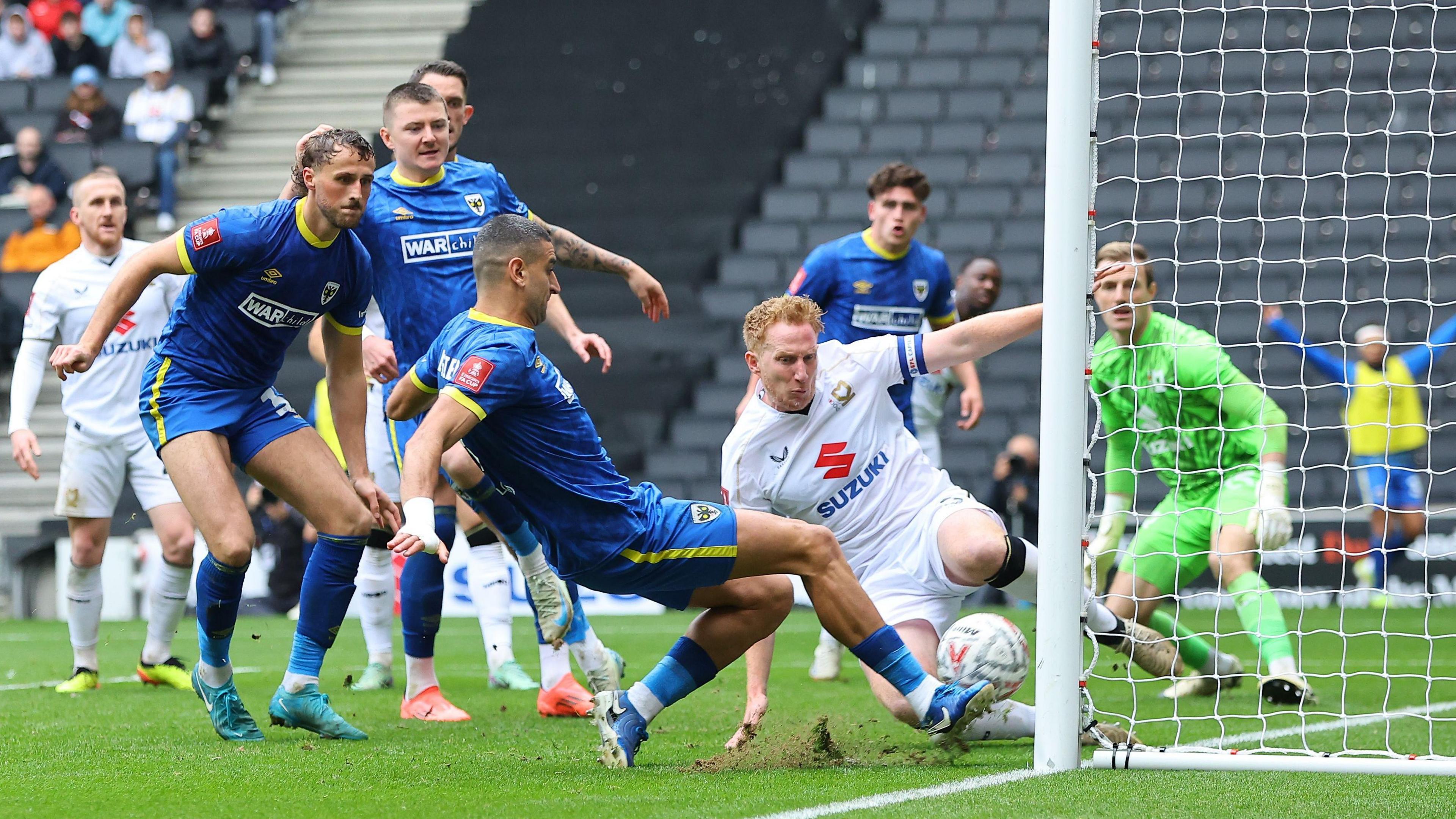 Omar Bugiel scores AFC Wimbledon's second goal from close range