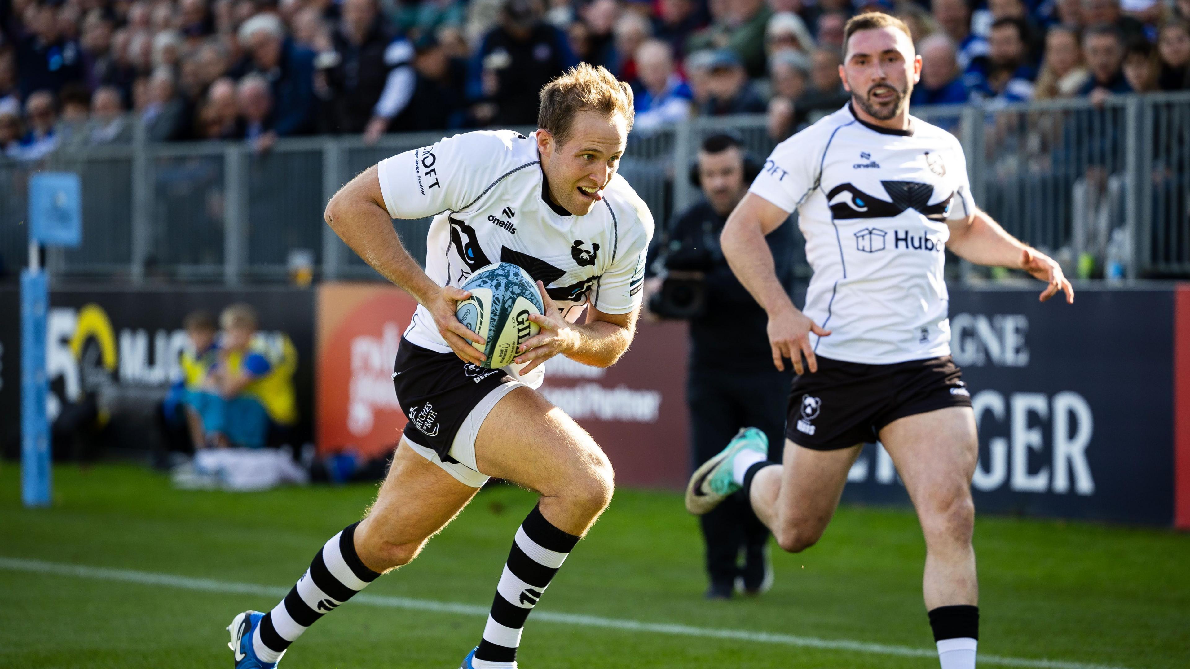 Max Malins (left) runs over to score for Bristol