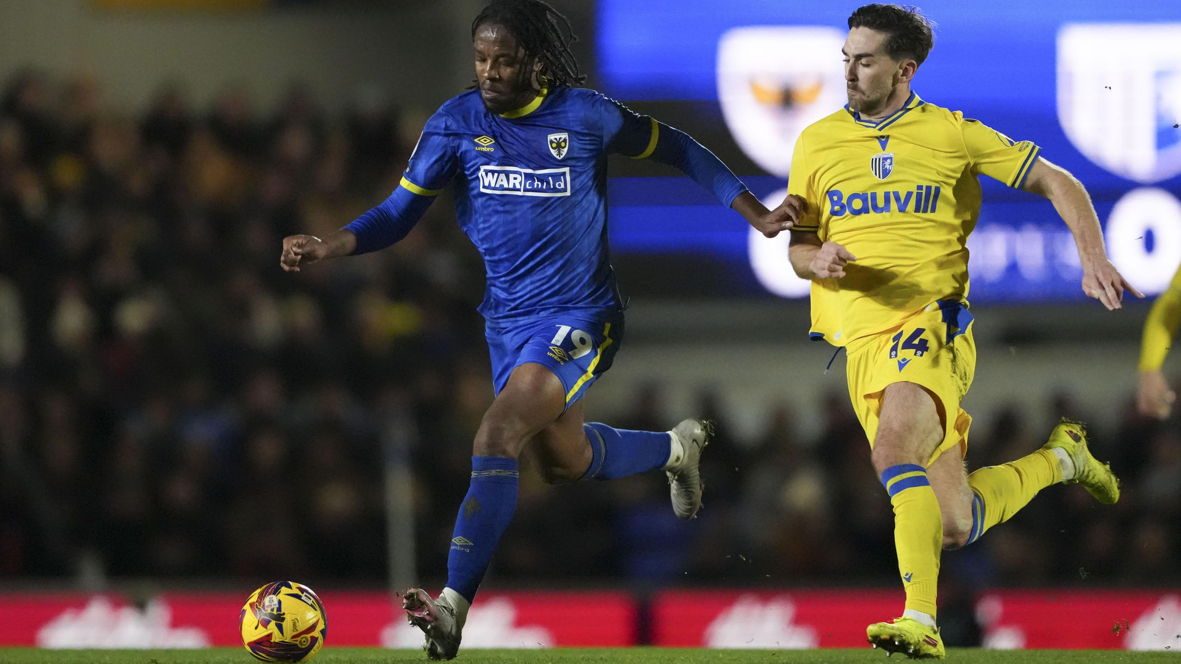 Romaine Sawyers of AFC Wimbledon and Robbie McKenzie of Gillingham