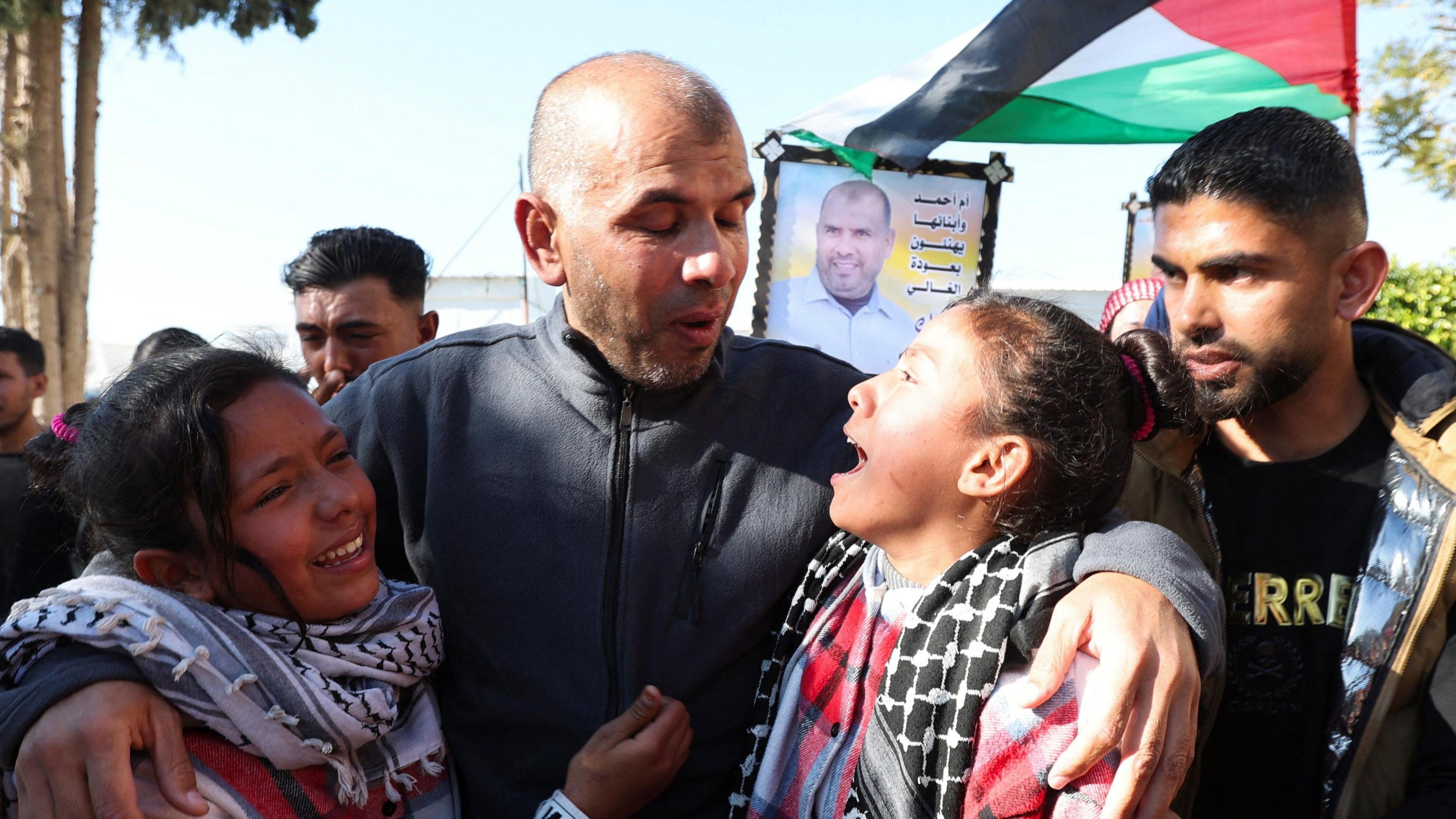 A freed Palestinian prisoner embraces children after being released, in Khan Younis.