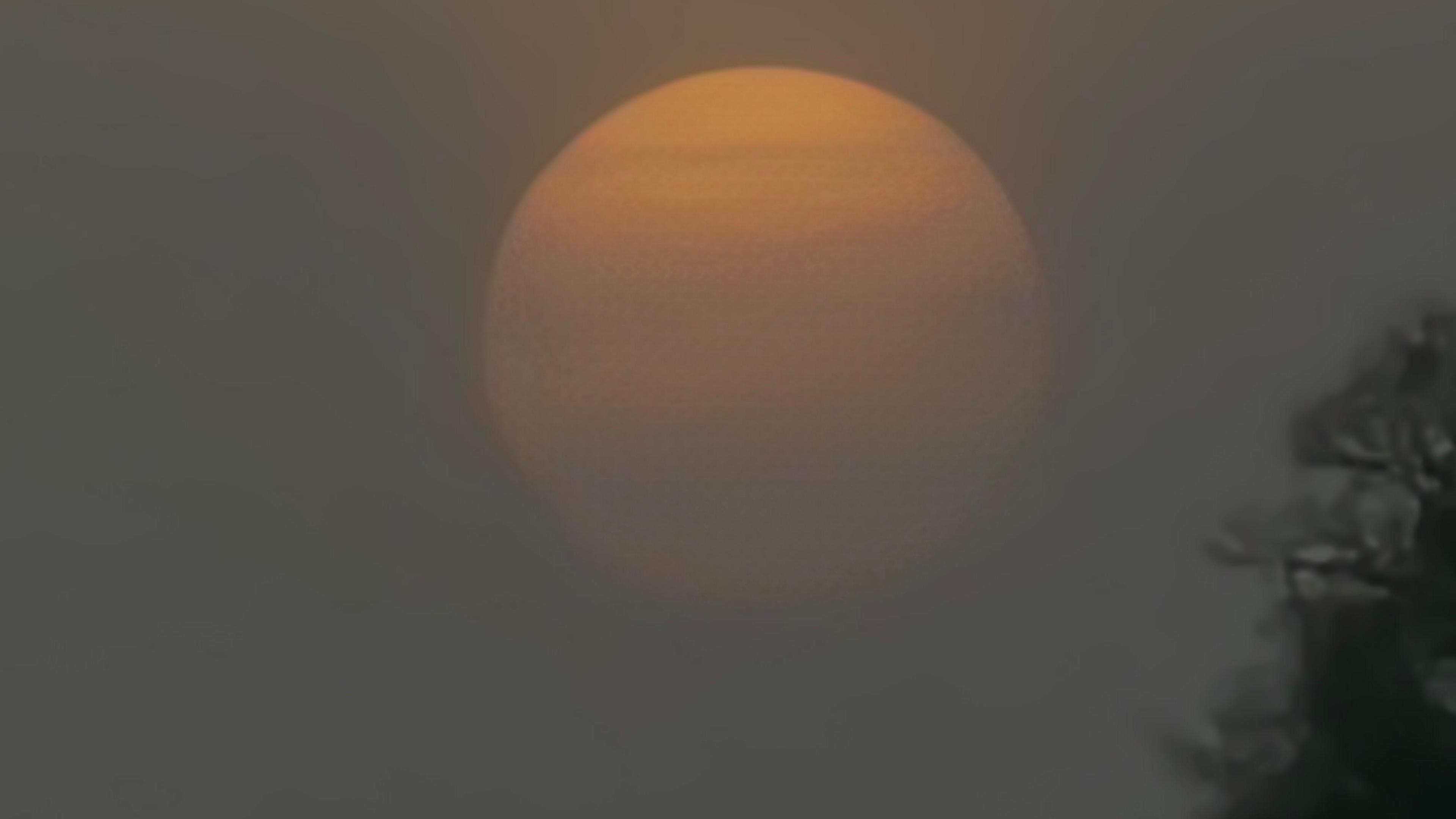 Sun in sky obscured by grey haze