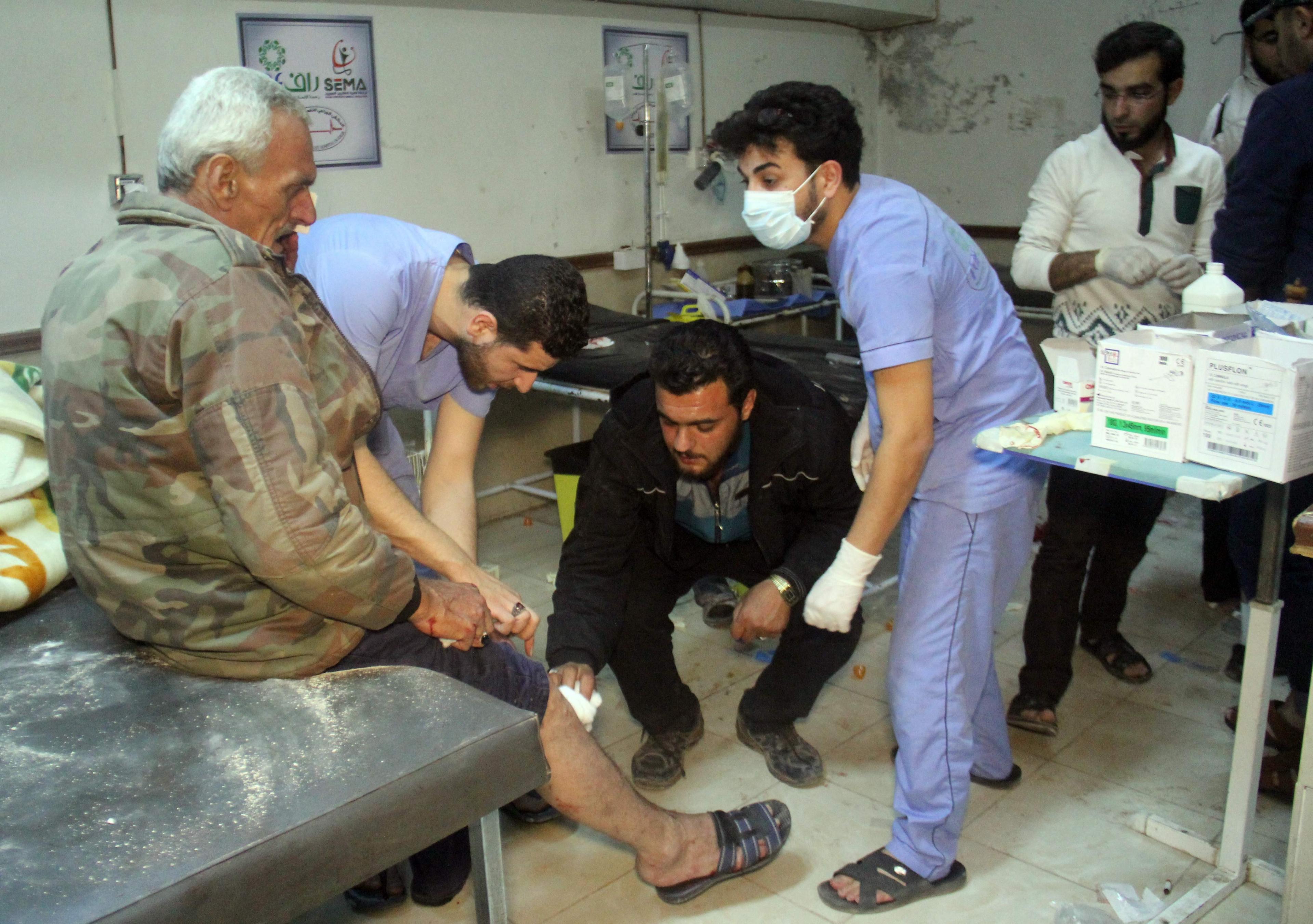 Medical staff treat a wounded victim at a hospital following air strikes that targeted Idlib on 31 May