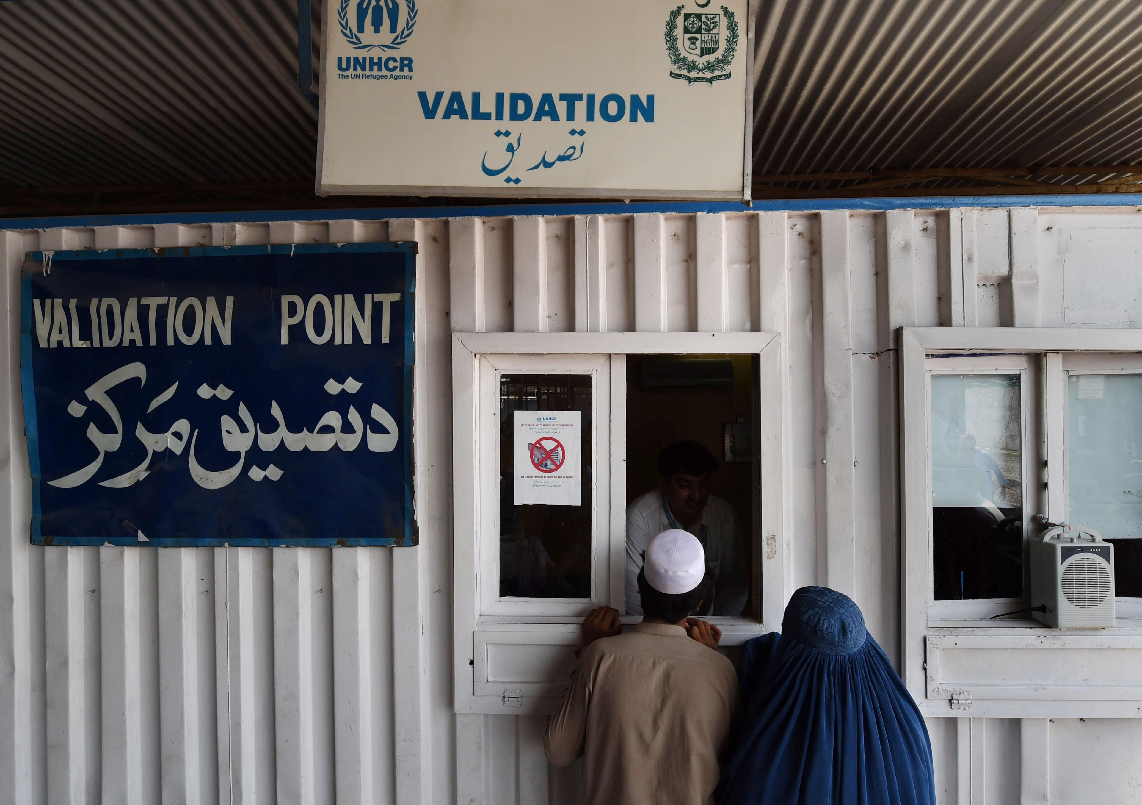 Couple registering with the United Nations High Commission for Refugees repatriation centre in Pakistan