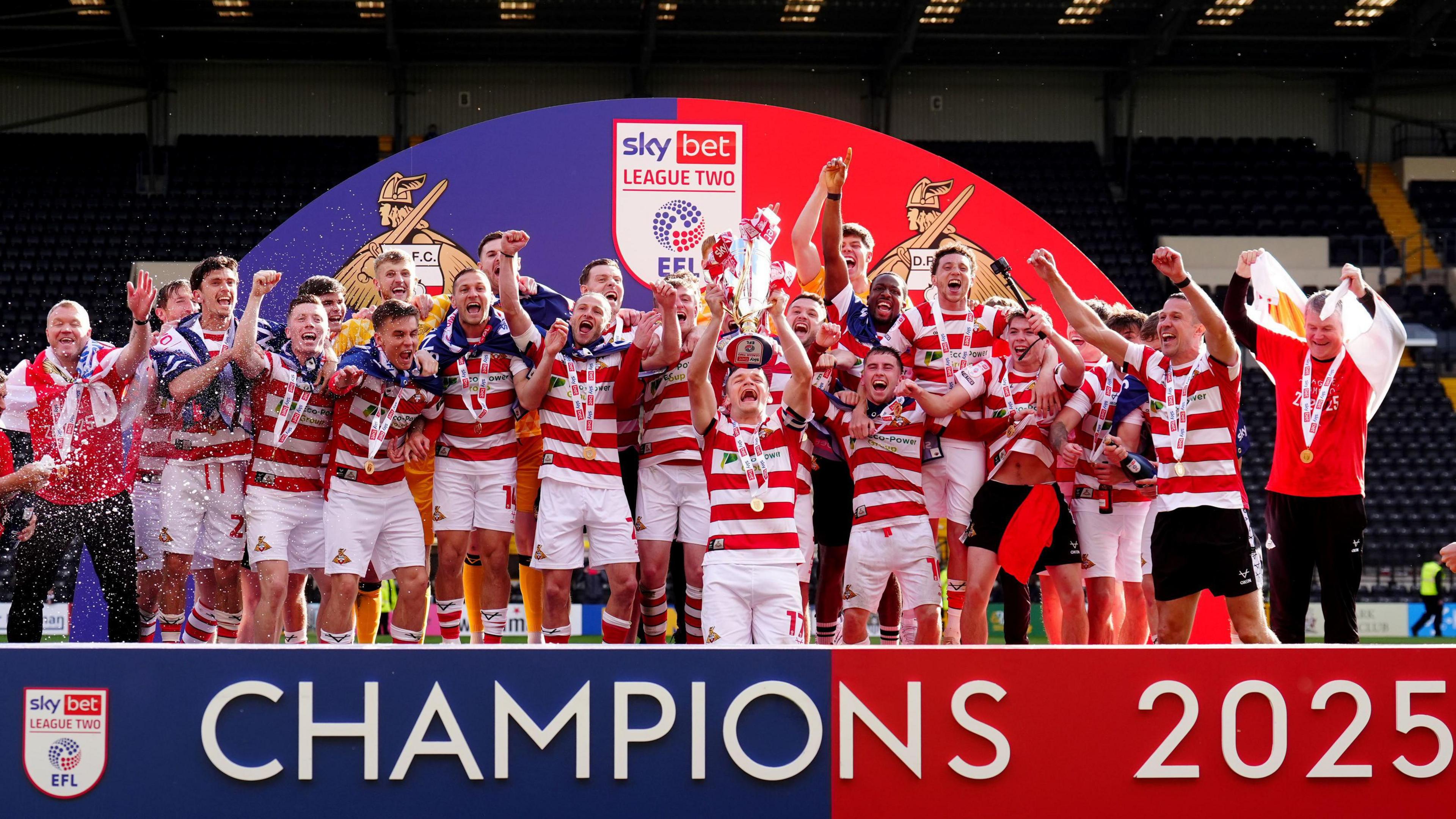 Doncaster celebrate with the League Two trophy