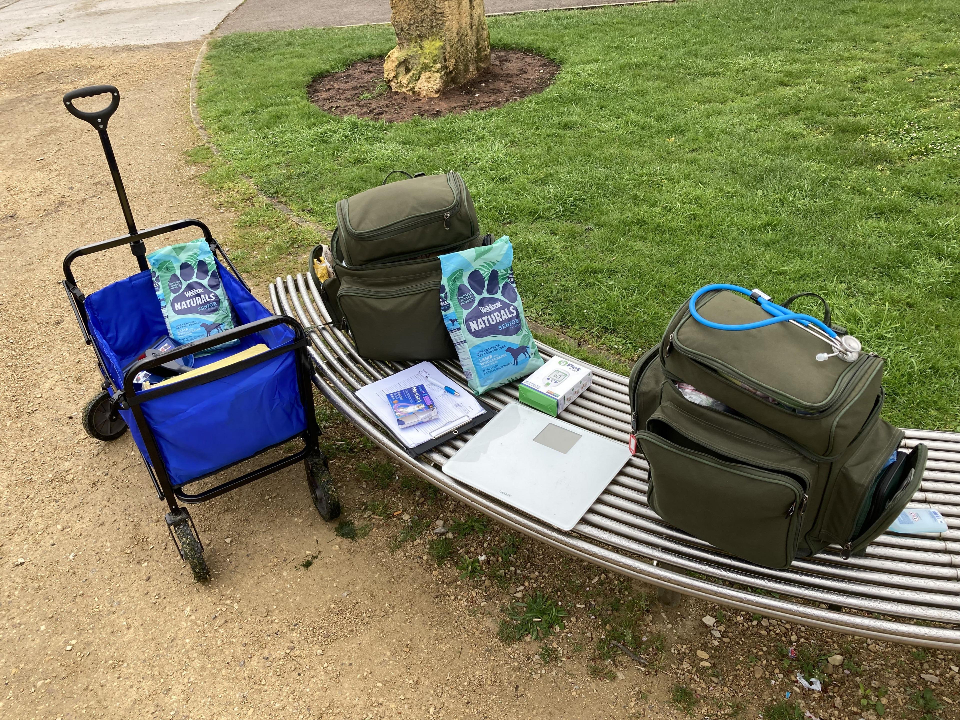 A picture of a trolley and two backpacks filled with vet equipment