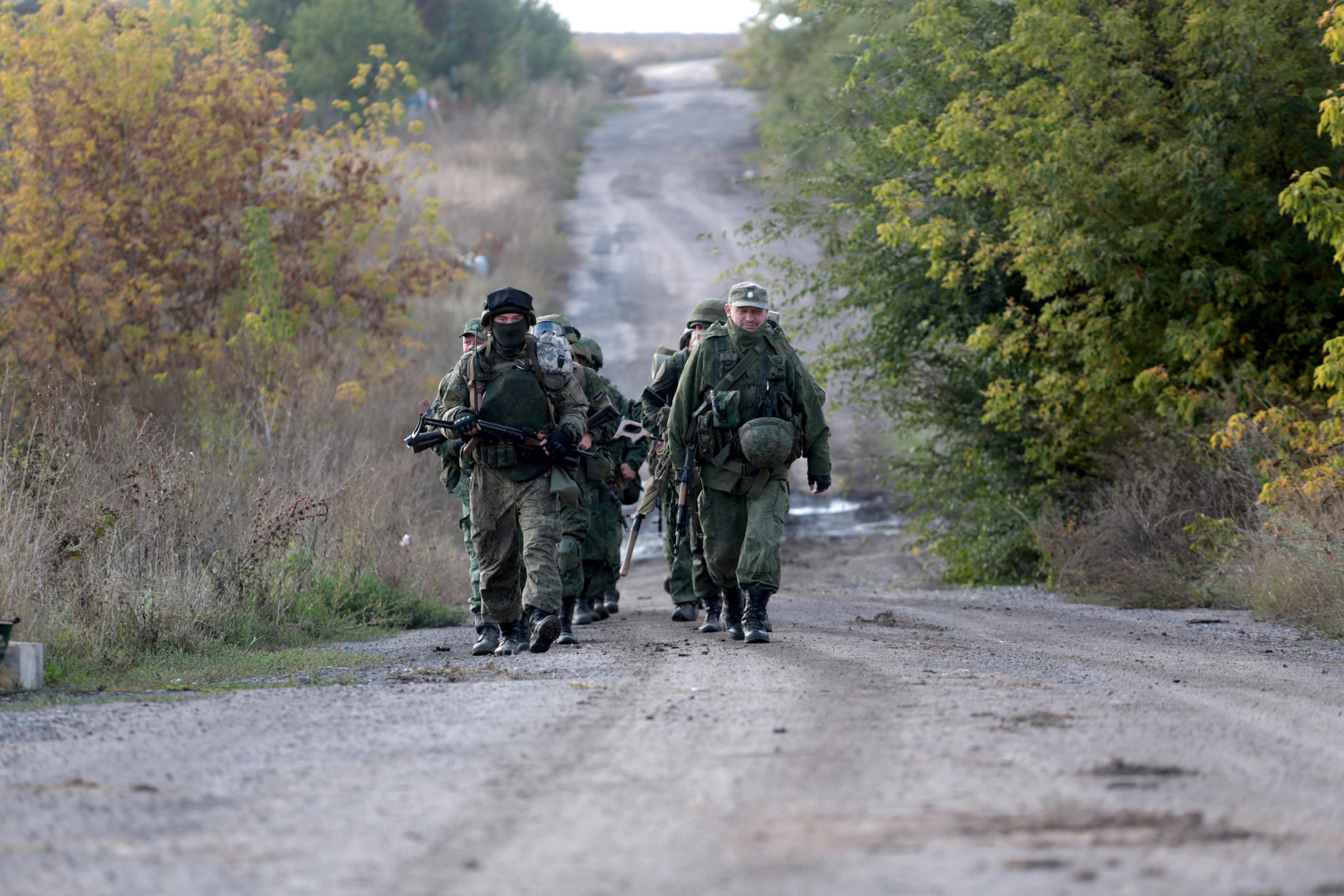 Pro-Russian separatists troops leave their position during withdrawal in the village of Petrovske, some 50 km from Donetsk, on 3 October, 2016