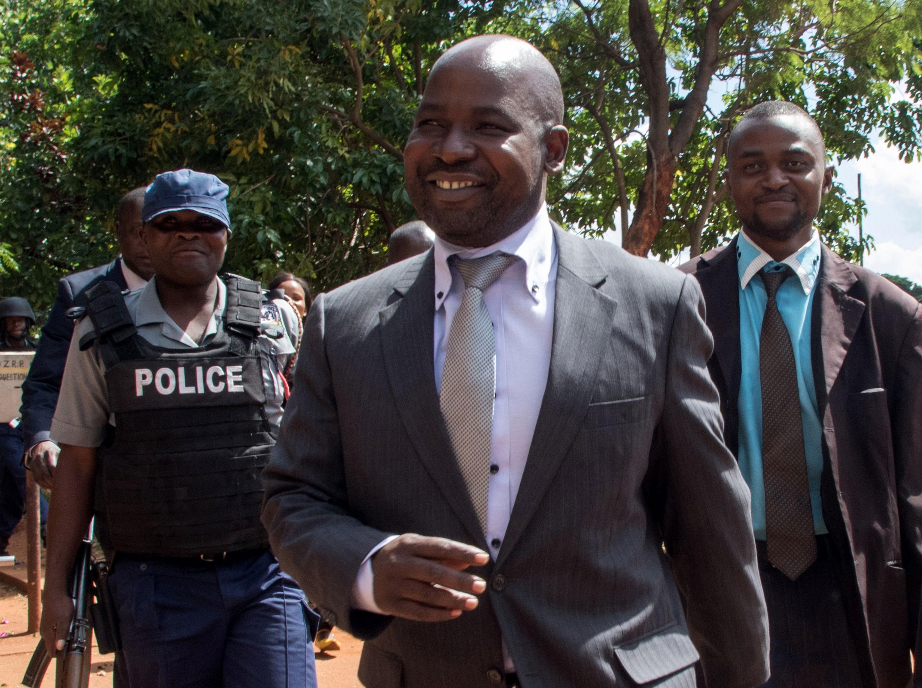 Zimbabwe's chief prosecutor Johannes Tomana (C) arrives at the Harare Magistrates court on February 2, 2016