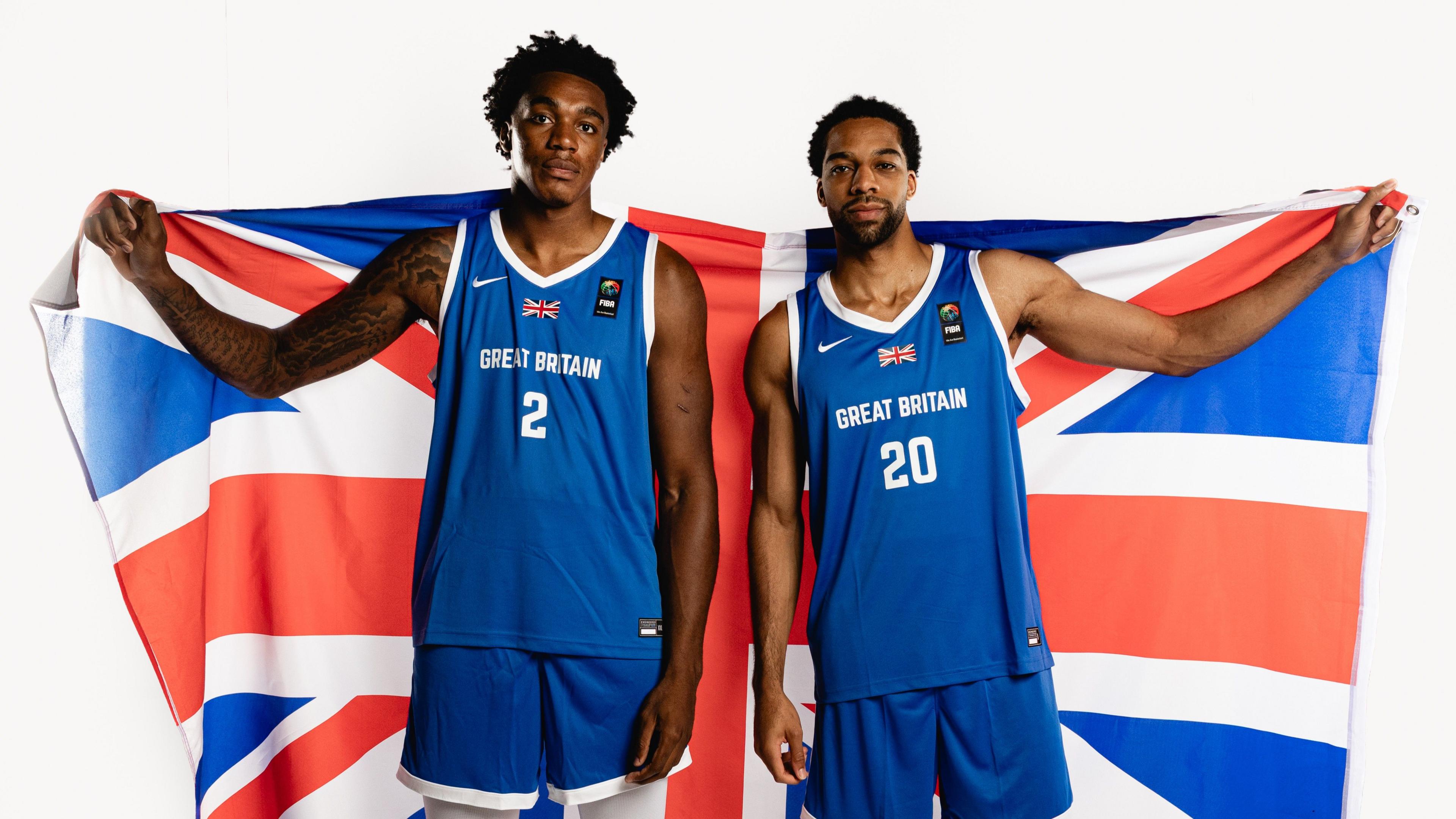 Amari Williams and Tosan Evbuomwan holding up a Great Britain flag while in Great Britain jerseys