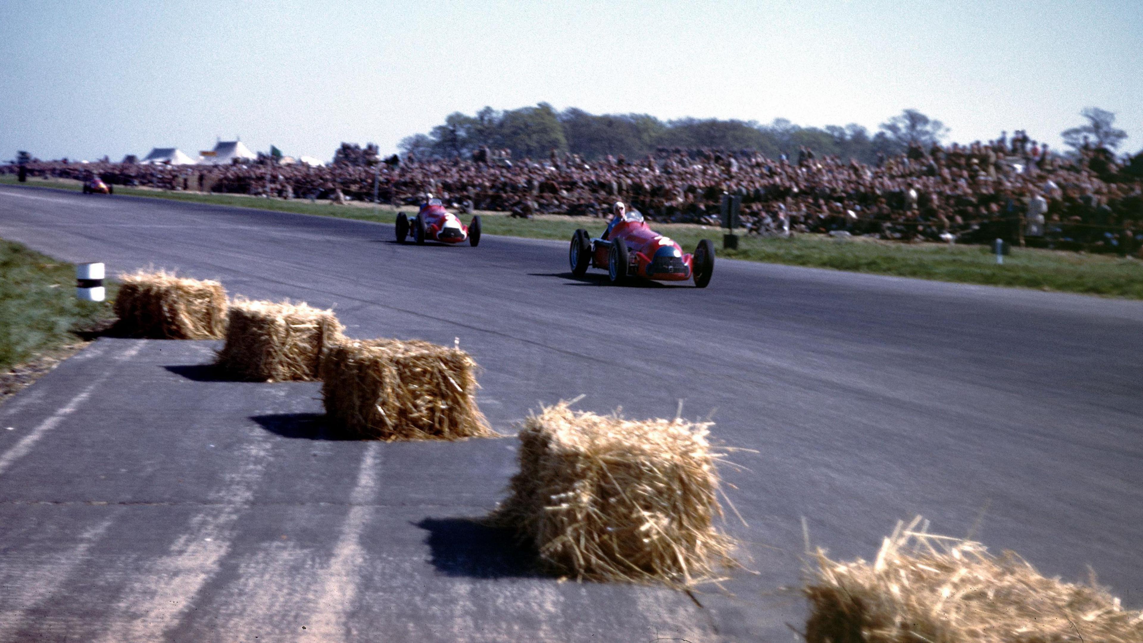 The Alfa Romeo 159 of Giuseppe Farina leading the sister car driven by Luigi Fagioli during the 1950 British Grand Prix at Silverstone