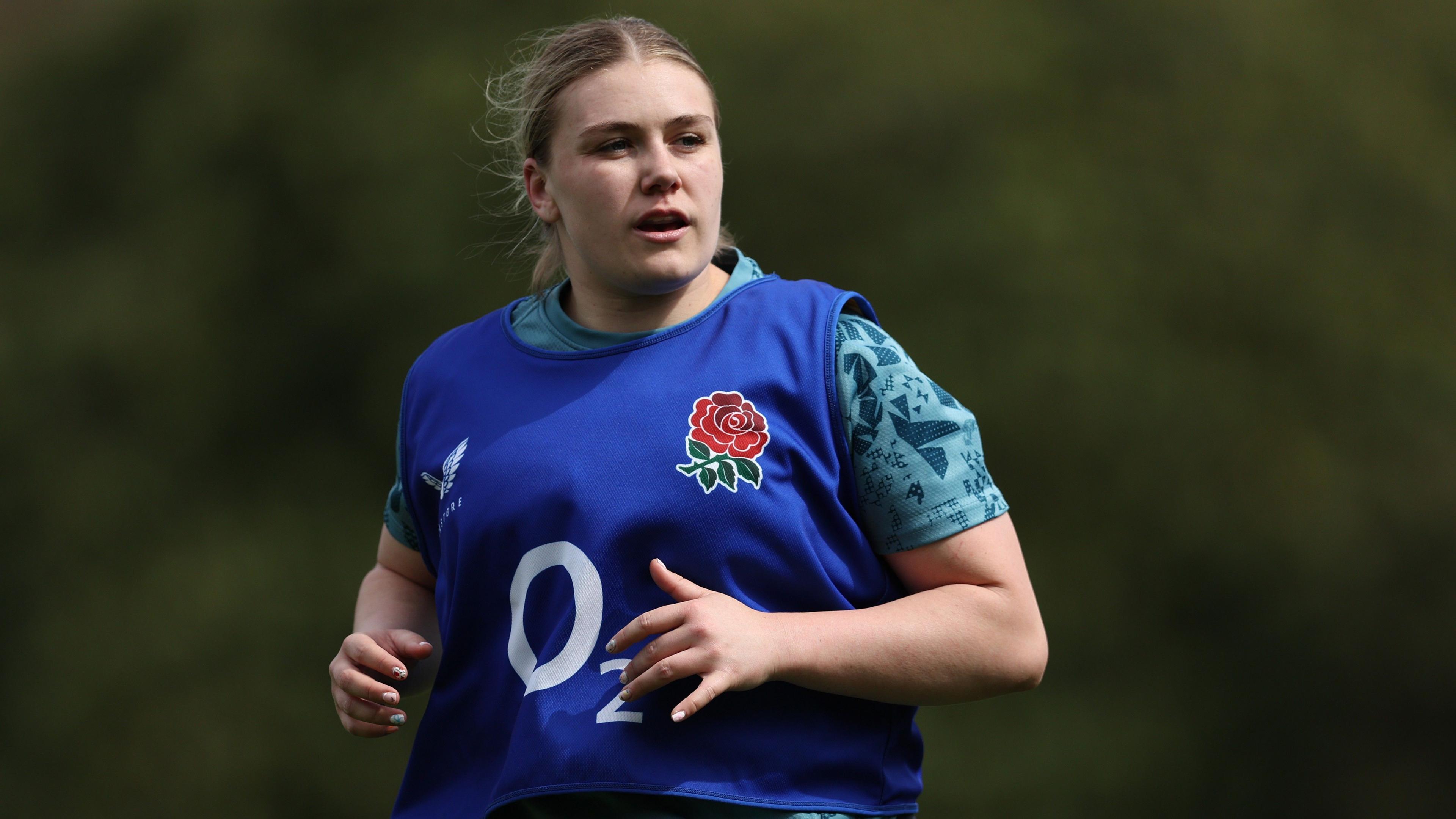 England Women's rugby international Mackenzie Carson wearing a blue bib while taking part in a training session with her country.