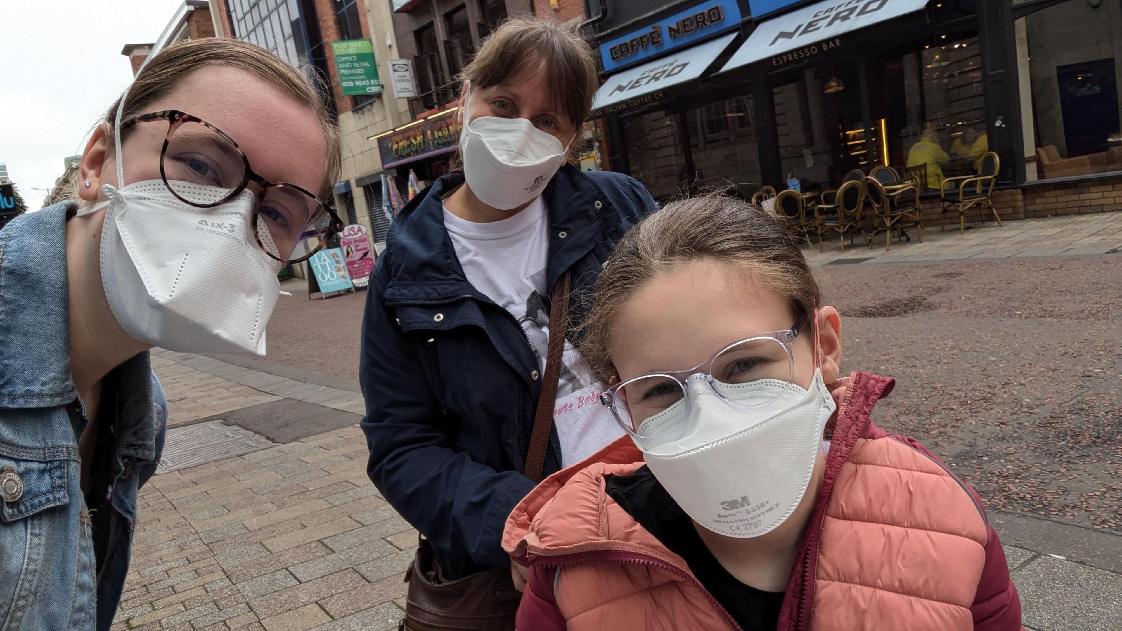 Seren and her mum Donna and sister Molly wearing masks in Belfast city centre