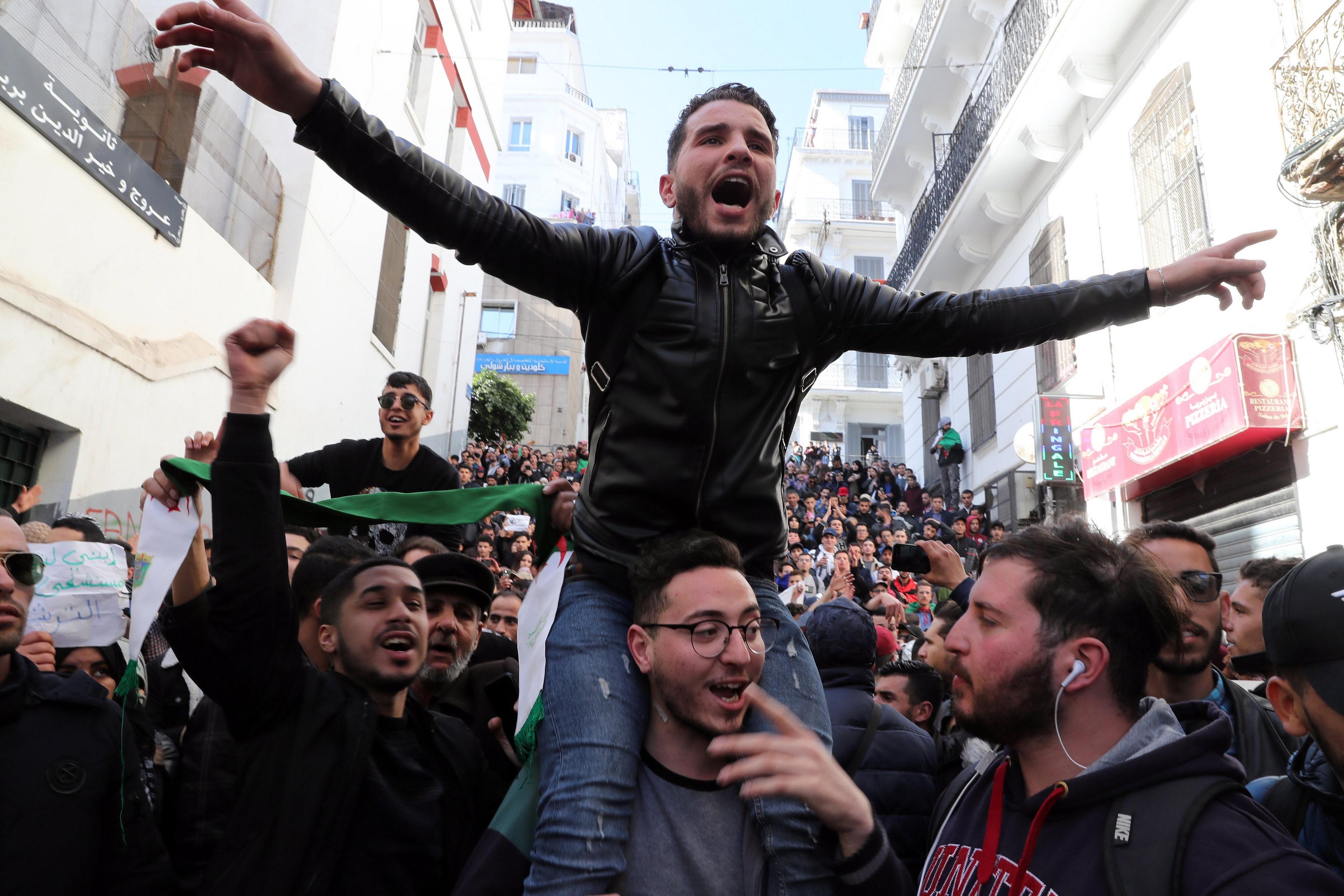 Algerian protesters chant slogans during a protest against the fifth term of Abdelaziz Bouteflika in Algiers