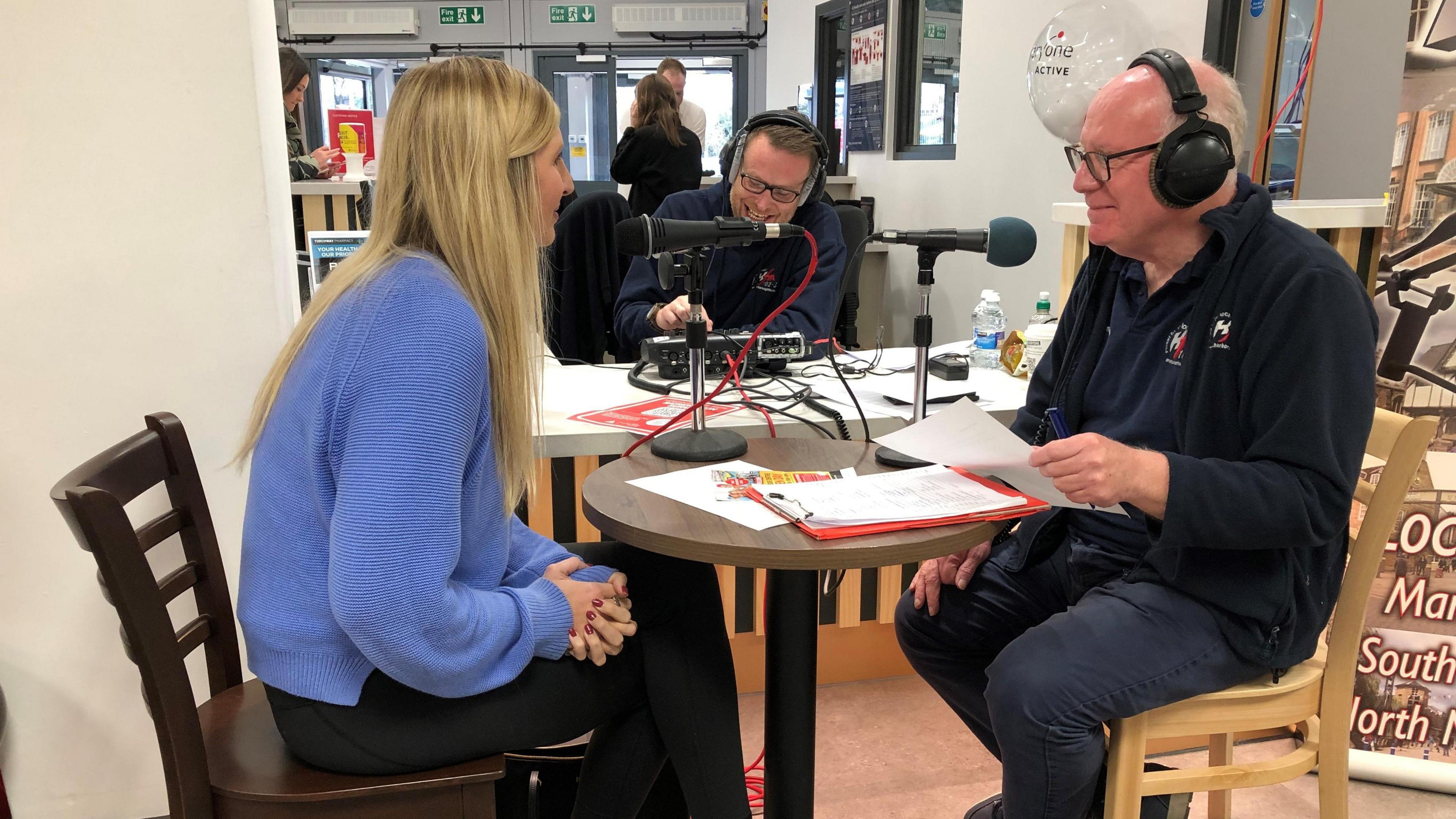 Hfm broadcasting from the leisure centre live with Rebecca Adlington, around a small table and chairs