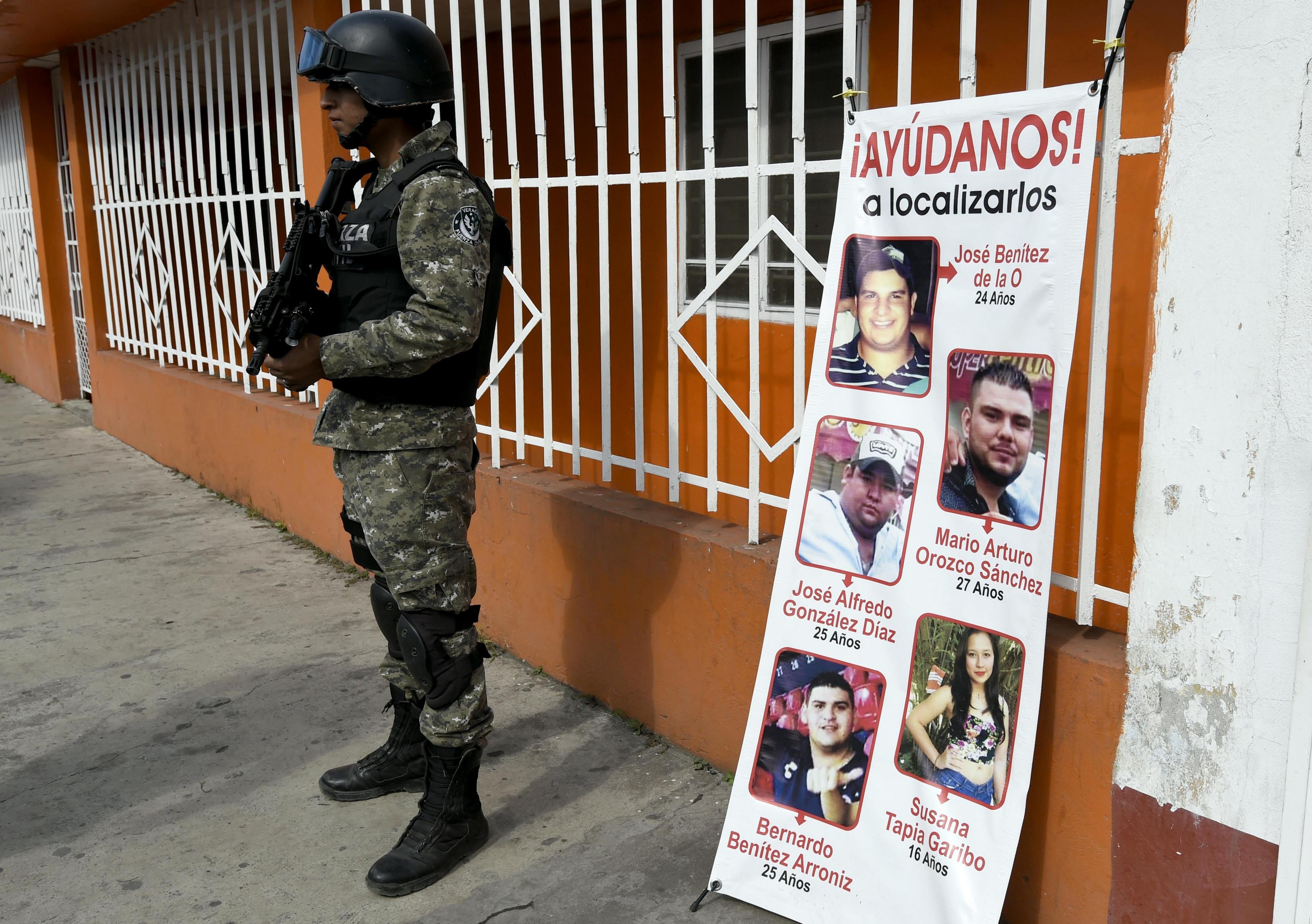 A banner showing the five youths who went missing in Tierra Blanca in January 2016