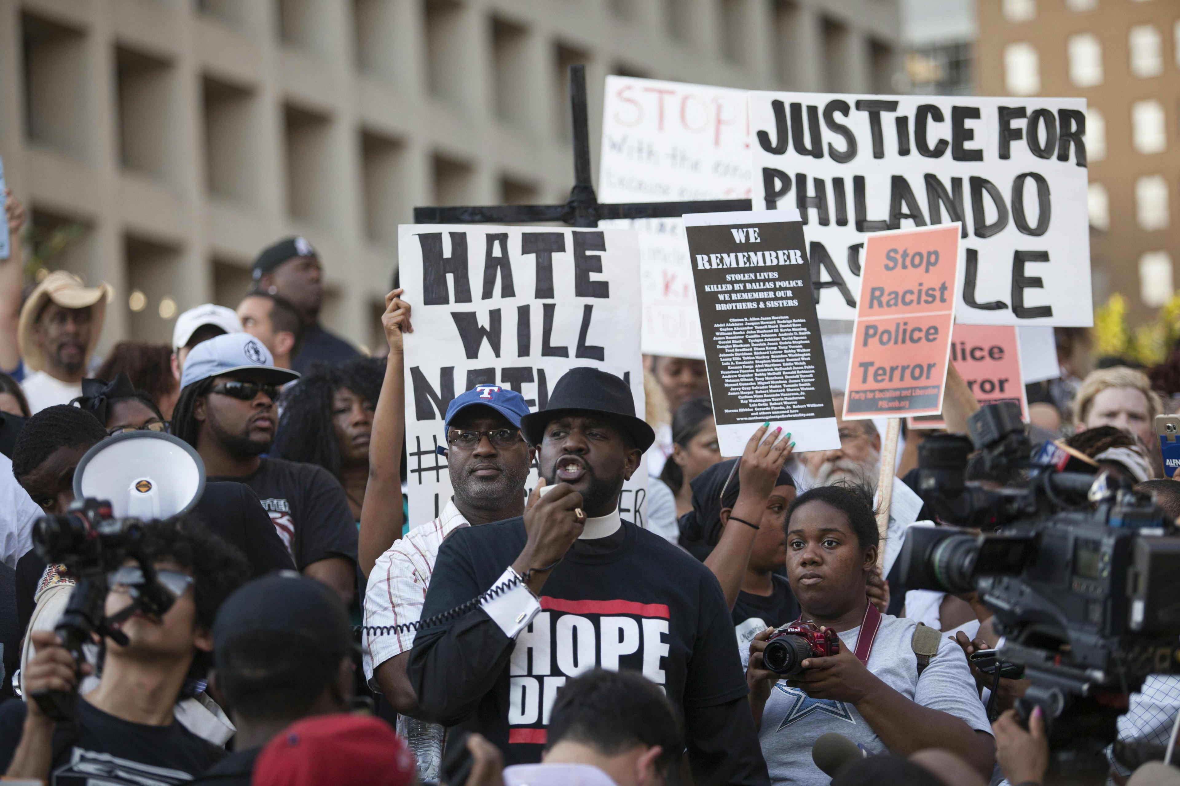 People rally in Dallas, Texas, on Thursday, 7 July 2016 to protest the deaths of Alton Sterling and Philando Castile